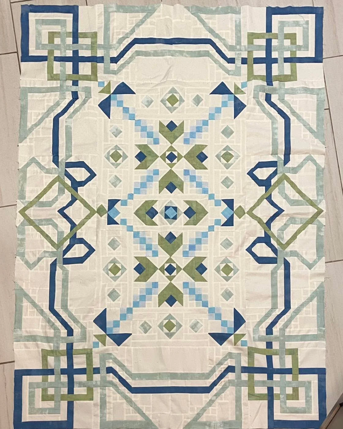 Definitely not for a paying client!  Over 1200 pieces of fabric stitched together painstakingly over at least 6 long weekend retreats.  I had to spend some non-retreat time over this last weekend, but the top is finally finished. I&rsquo;m kinda prou