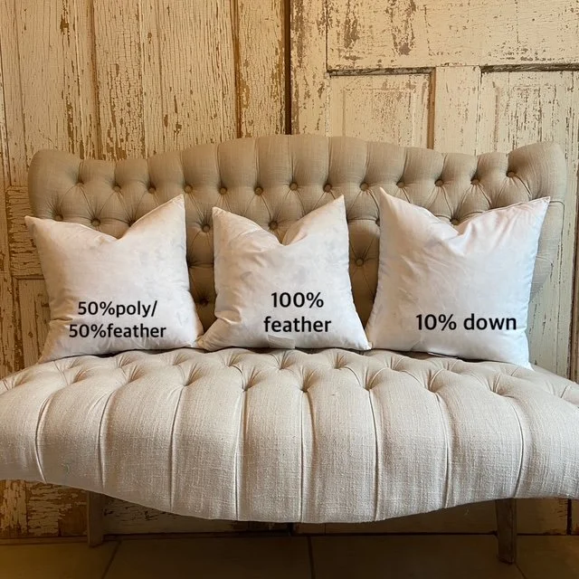 three pillows of different feather percentages on a bench