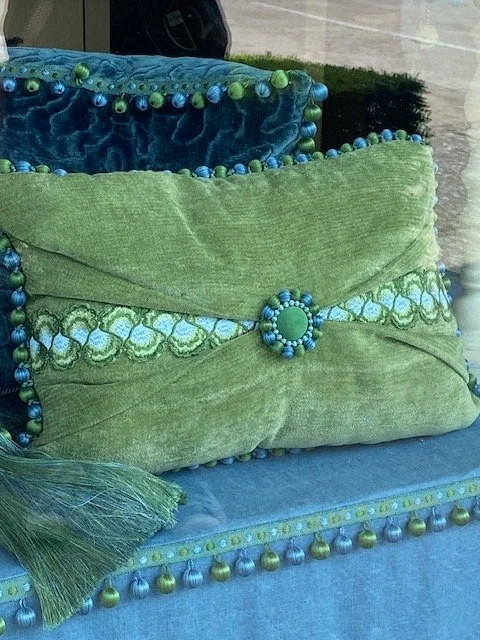 green velvet pillow with pleated front and multiple trims