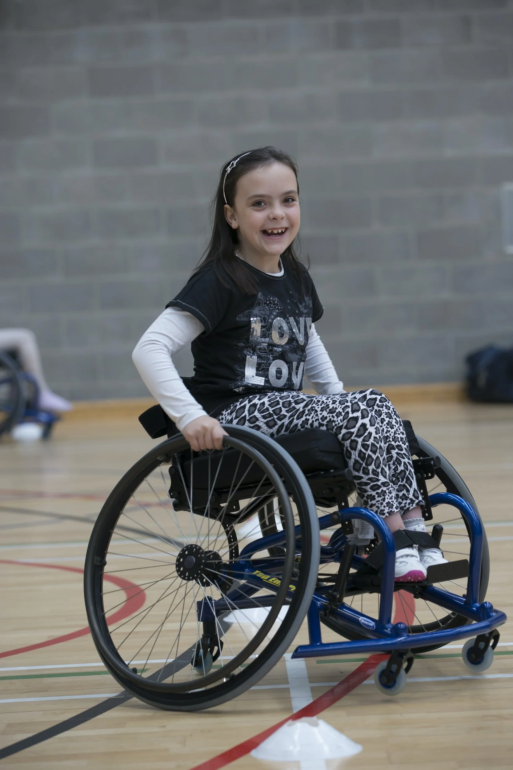 Smiley girl in sports wheelchair