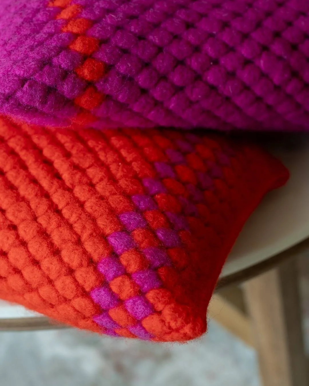 Colorful crochet cushions in Ana Sebastião’s signature Kabanita stitch, blending puff stitches with vibrant yarns in this crochet pattern.