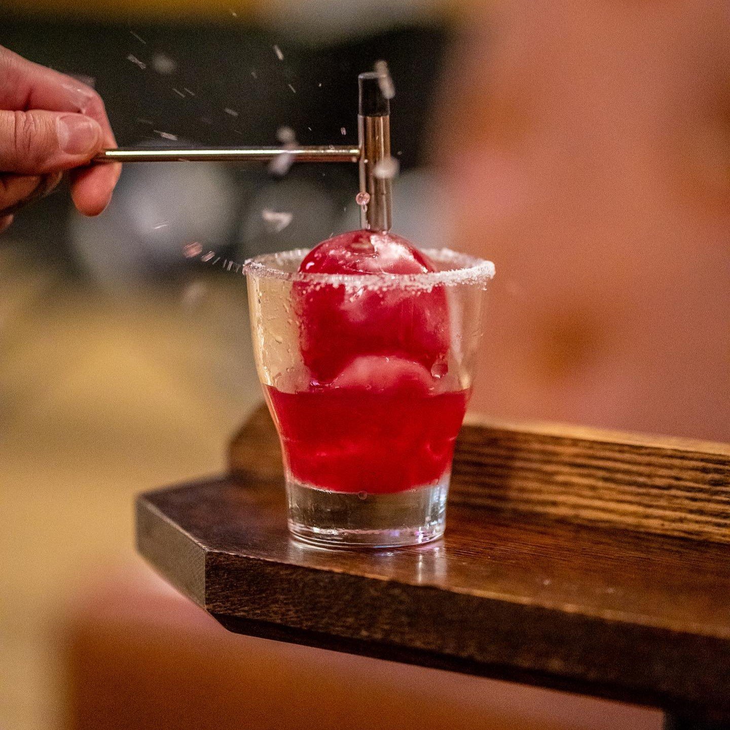 The Dragon Ball Z cocktail comes in an ice ball that is broken with a small bar hammer.jpg