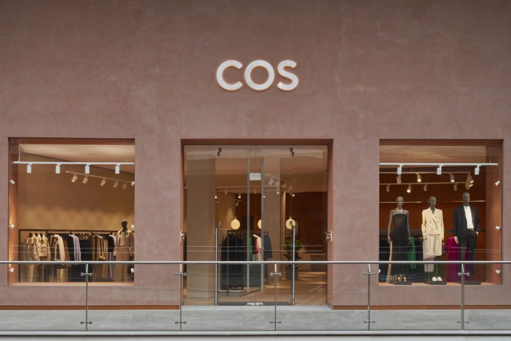 COS retail shop with stainless straight handles for a glass door.