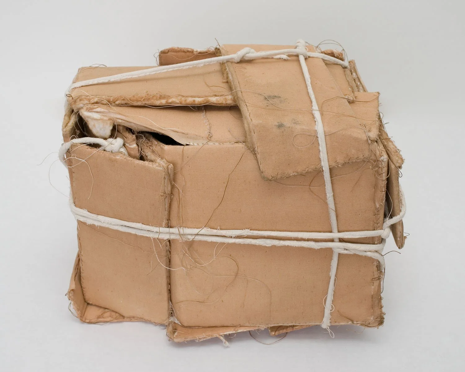 "Unattended Suspicious Package", 2006, Plywood, stained muslin, cord, thread, 10 x 9 x 14 inches