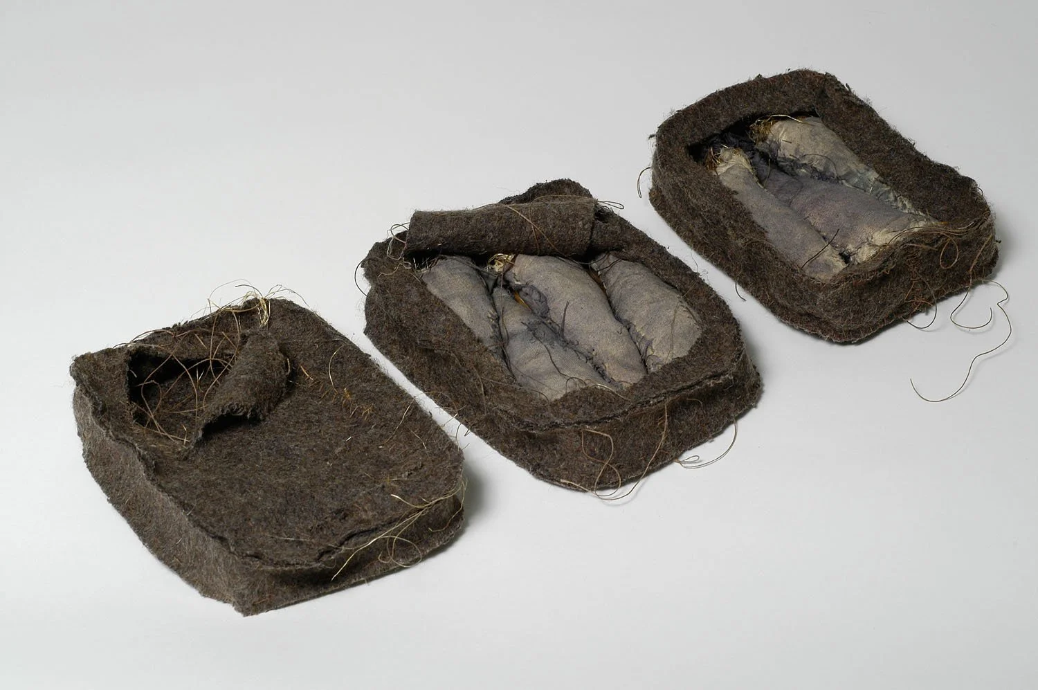 "Sardine Cans", 2004, Blanket, fabric, ink, thread, rope, 2 x 25 x 4.5 inches