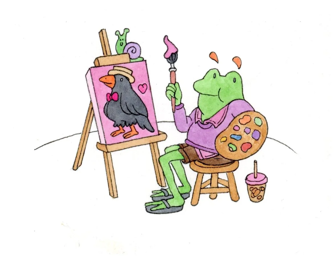 A cartoon frog sitting on a wooden chair, painting a picture of a crow with a pink bow tie and hat on an easel. The frog holds a paintbrush with pink paint, has a painter's palette on its back, and a cup of iced coffee on the floor beside it.