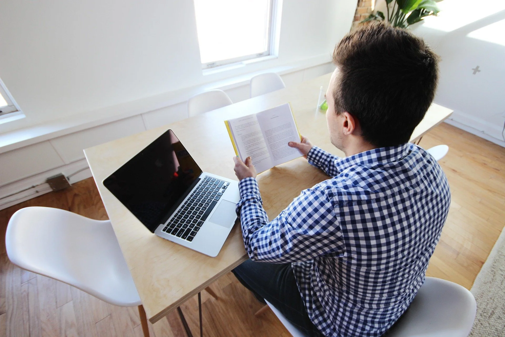Man reviewing documents and laptop for bankruptcy filing process