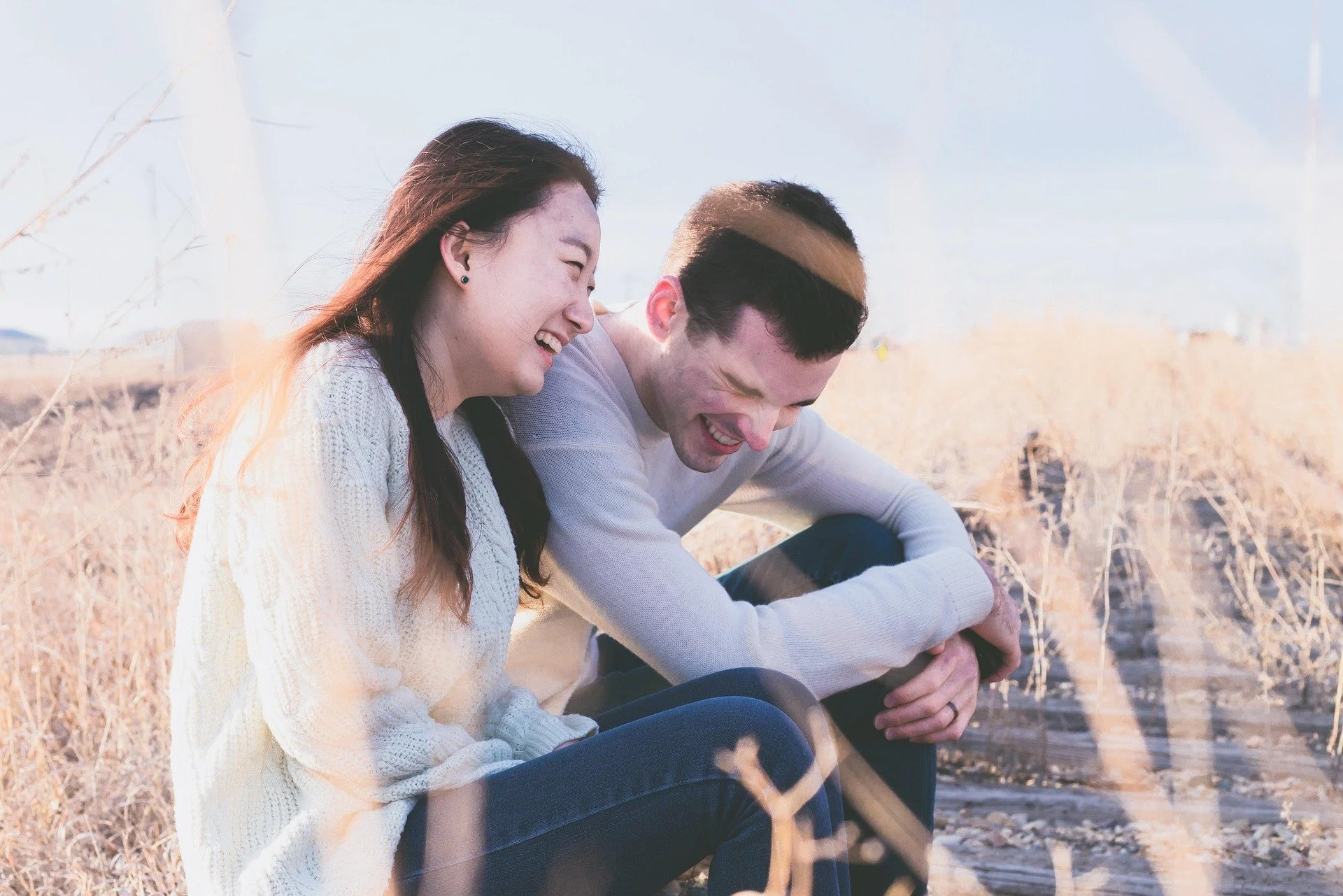 Unmarried couple laughing together while discussing their future and legal relationship rights