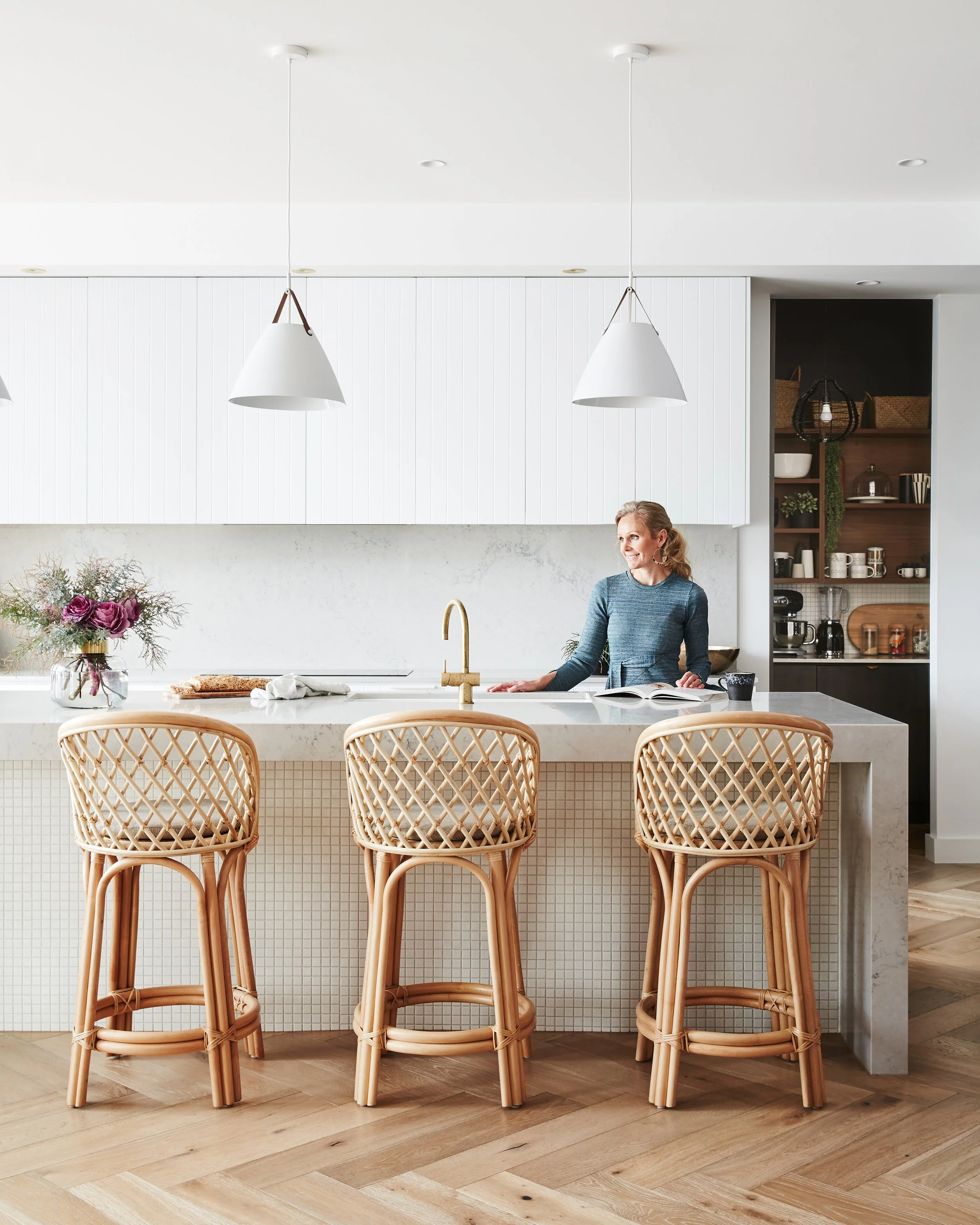 Kitchen with rattan cane stools and walk in pantry