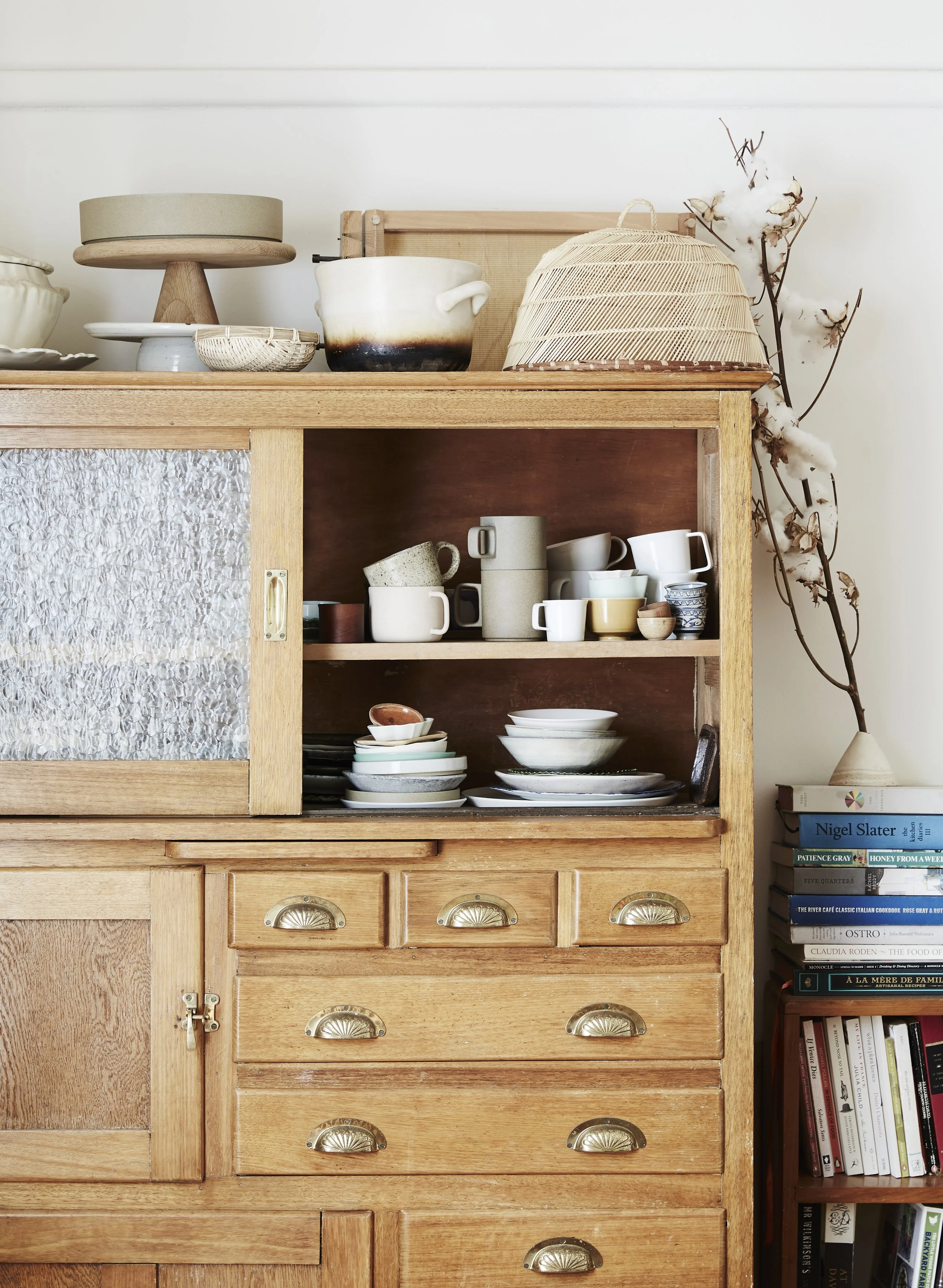 Julia Busuttil Nishimura home tour detail of kitchenware in vintage timber cabinet