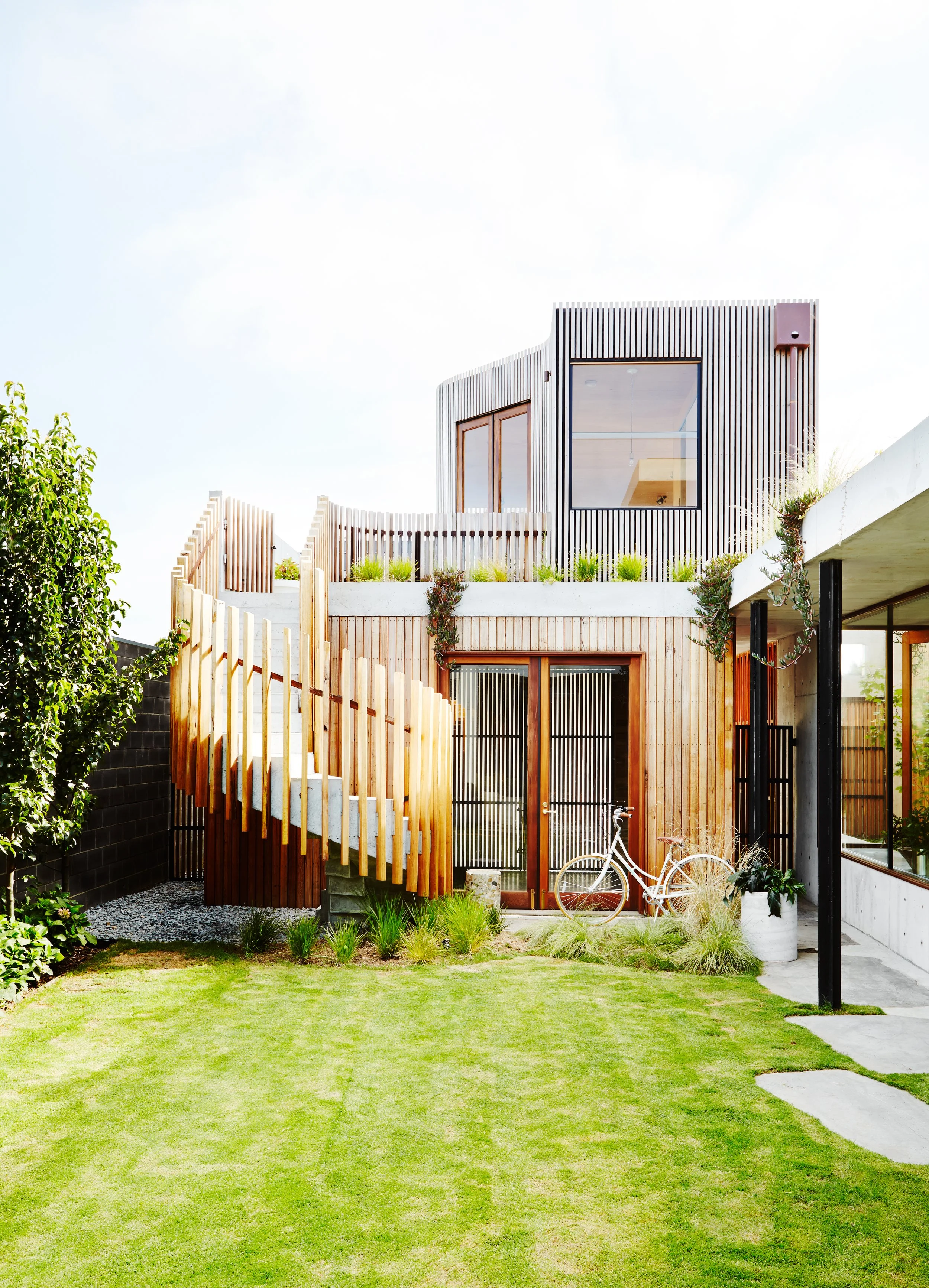 Torquay home by Auhaus, exterior with staircase and lawn