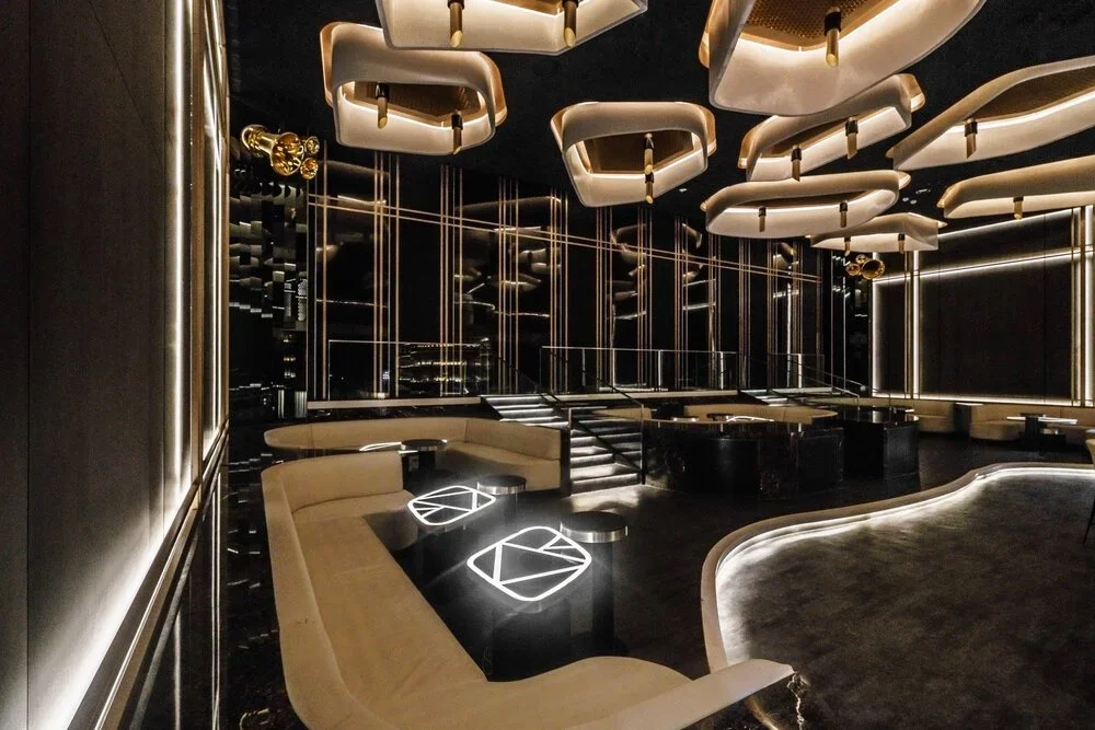 KOR Taipei – side lounge with curved banquette seating and glowing tables – hospitality interior – Taipei, Taiwan