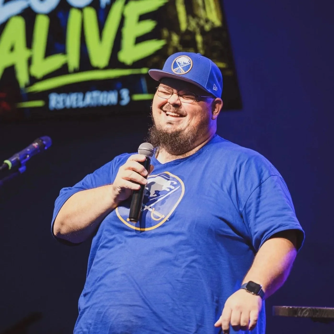 Pastor Garret Roux laughing while preaching to the Coastal Students.