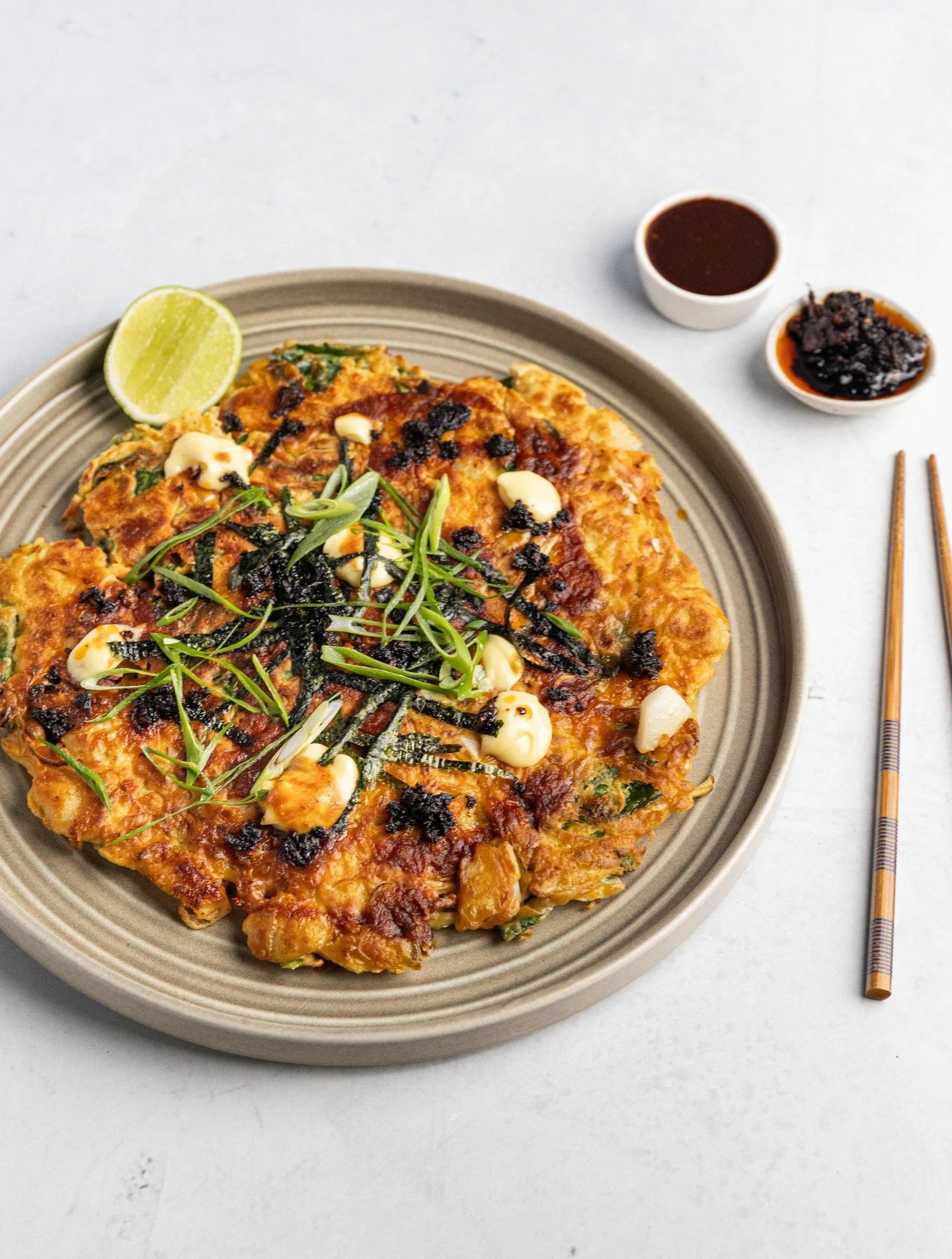 Japanese comfort food at its finest! 🔥 Jo's Seafood Okonomiyaki is loaded with fresh veggies and seafood and drizzled with @ayamaustralia crispy chilli oil for the ultimate flavour bomb. Crispy on the outside, tender on the inside, it is absolutely 