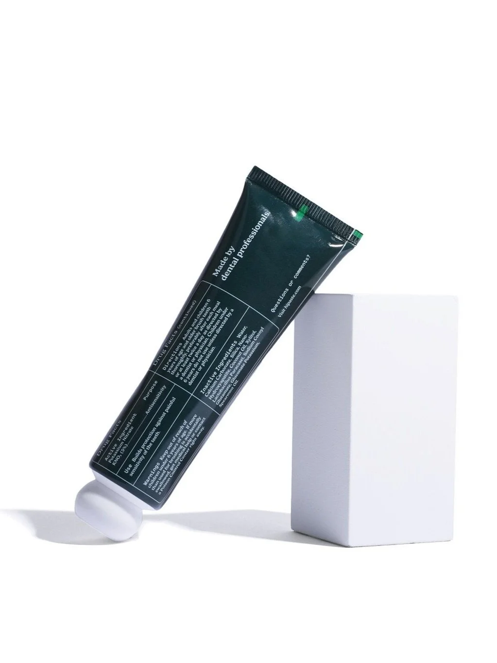 The back of the mint anti-sensitivity toothpaste tube, featuring directions and ingredients.