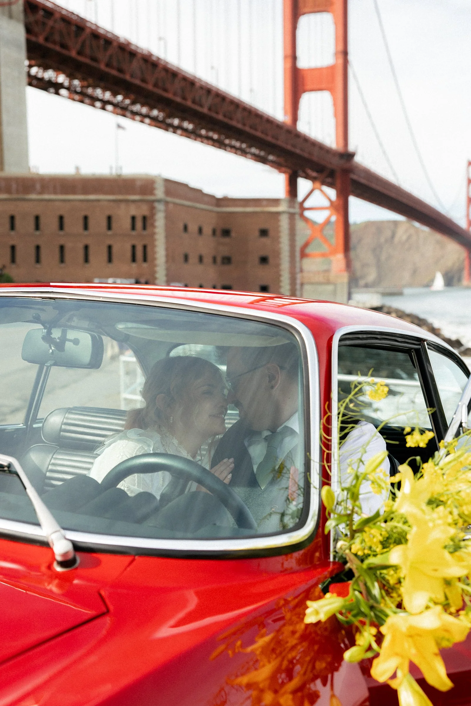 wedding portraits with a vintage alfa romeo car in san francisco california bay area golden gate back drop 