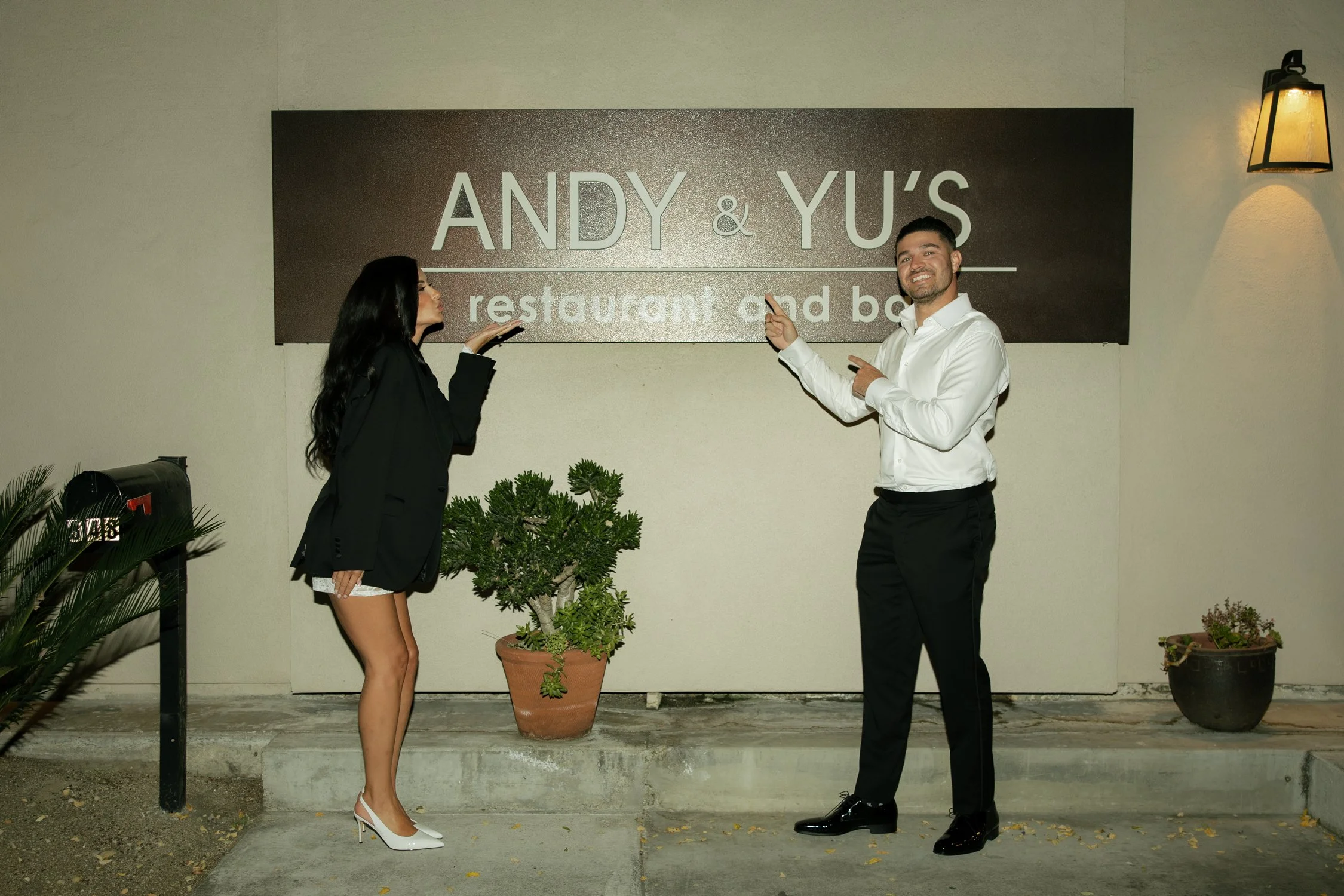 couple in front of andy and yu's restauraunt and bar