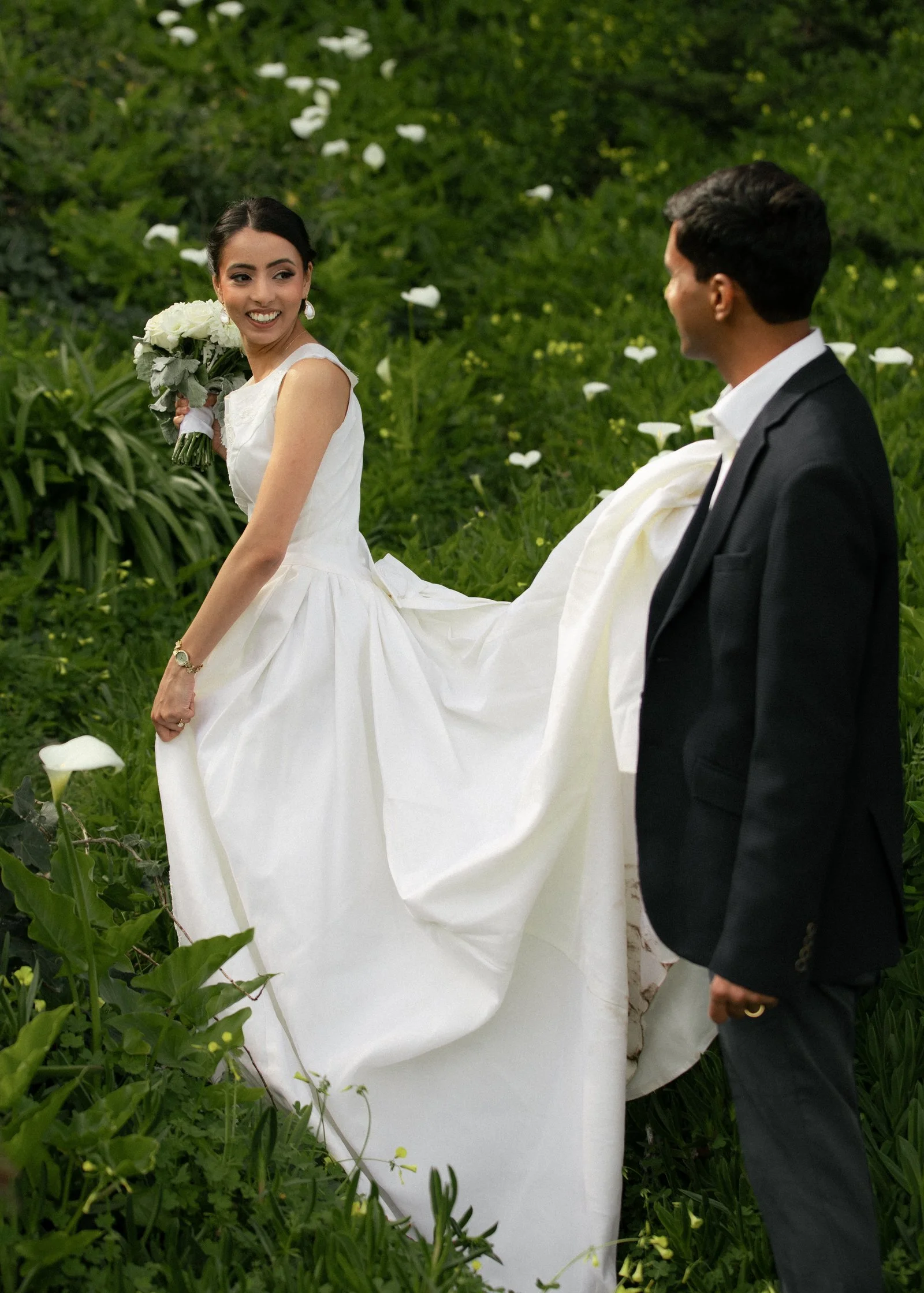 bride and groom portraits in a sea of green cala lilies