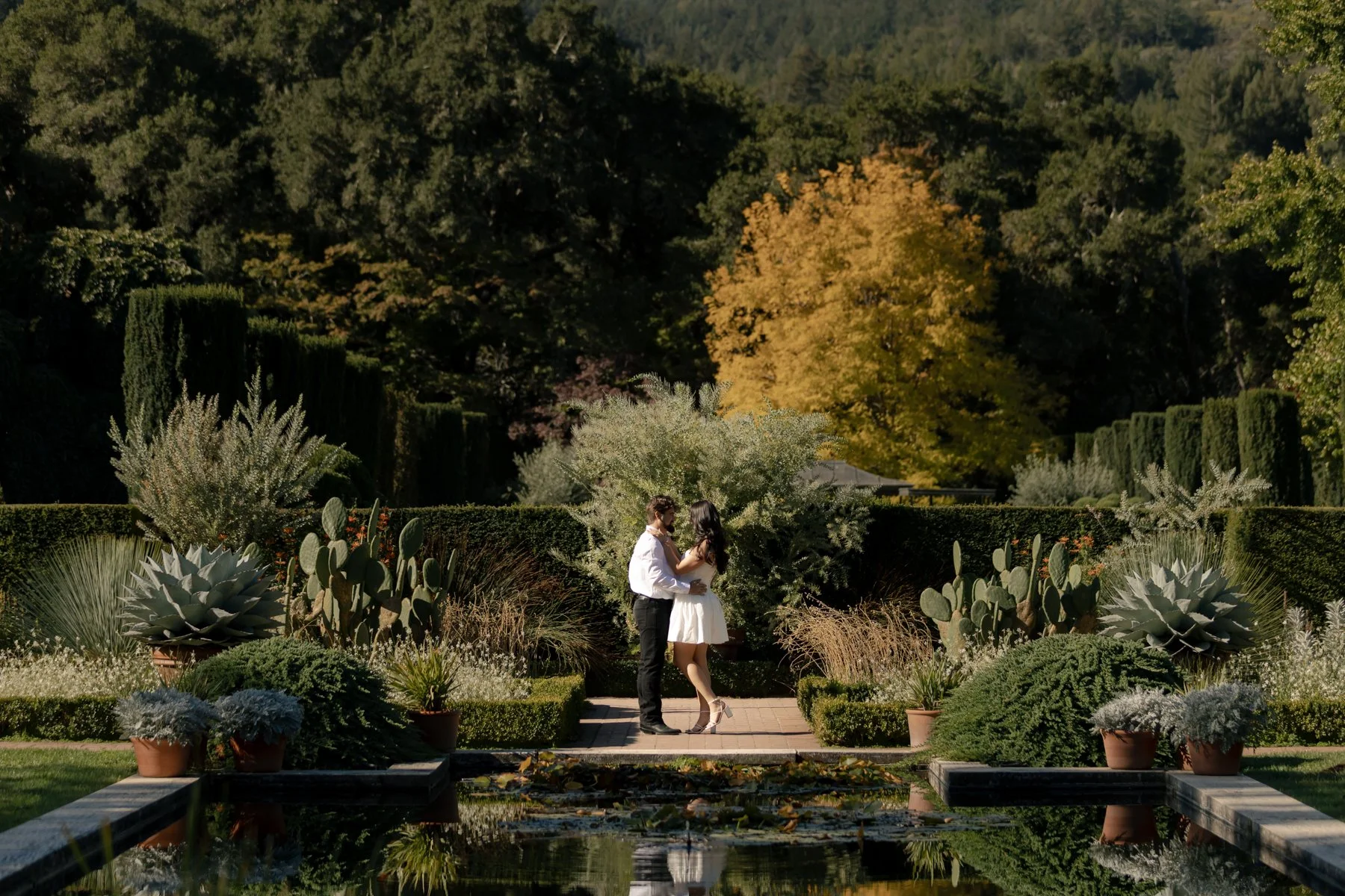couple in a garden in white outfits