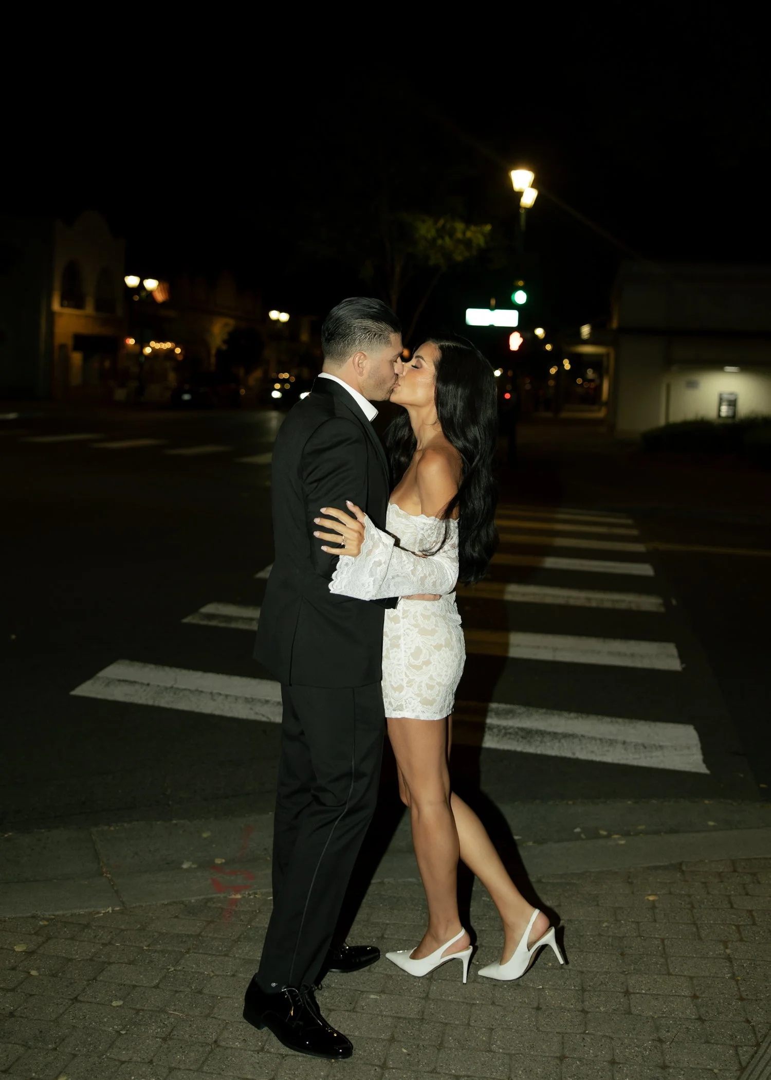 pleasanton-engagement-couple-walking-downtown-night outdoors