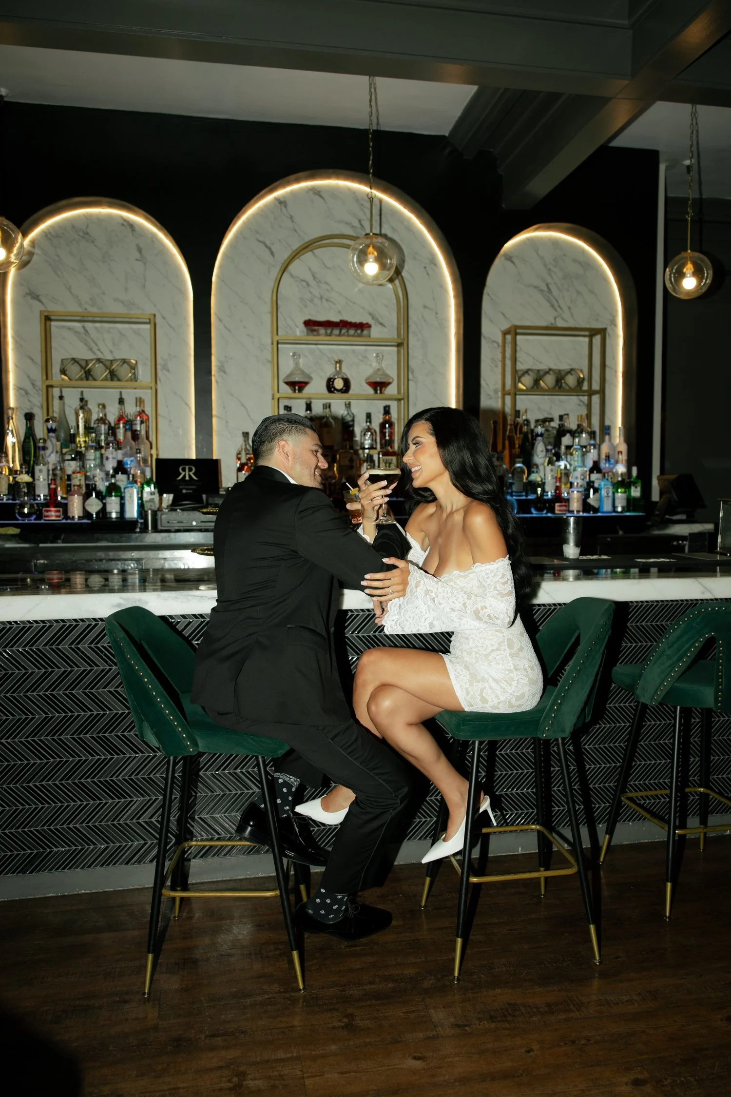 rubys-and-roses-engagement-session-bar-couple-flash-velvet-chairs.jpg