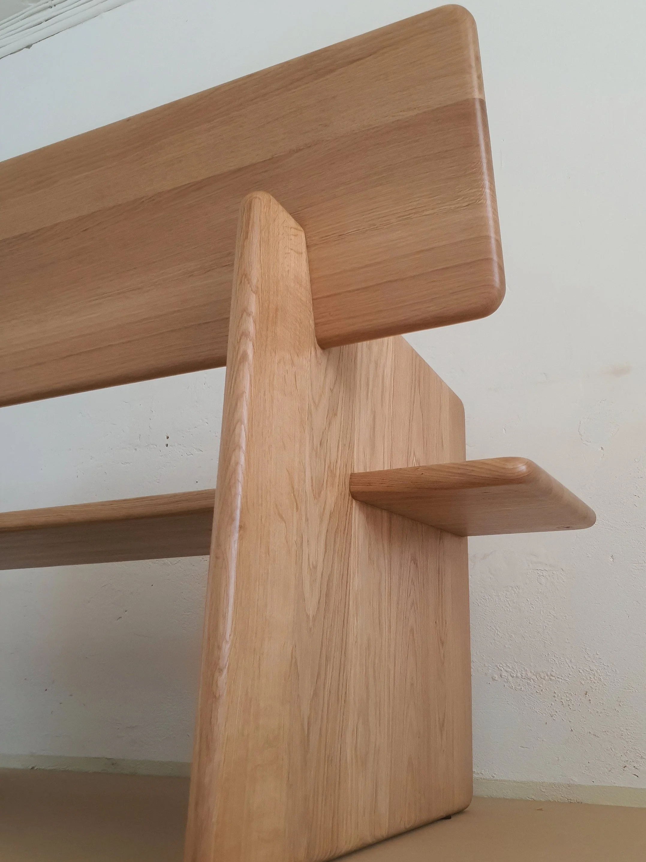 The hidden joinery gives the feeling that the planks interlace each other in a delicate manner