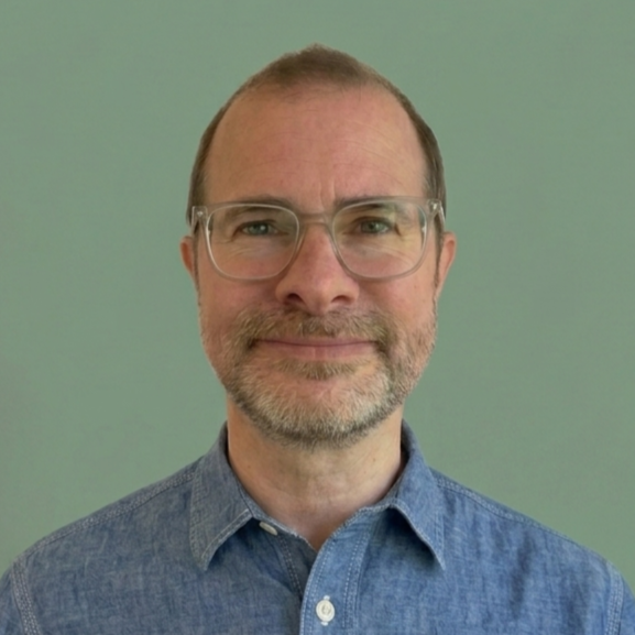Headshot of Will Dallimore, a consultant working with mission-led organisations, against a sage coloured background
