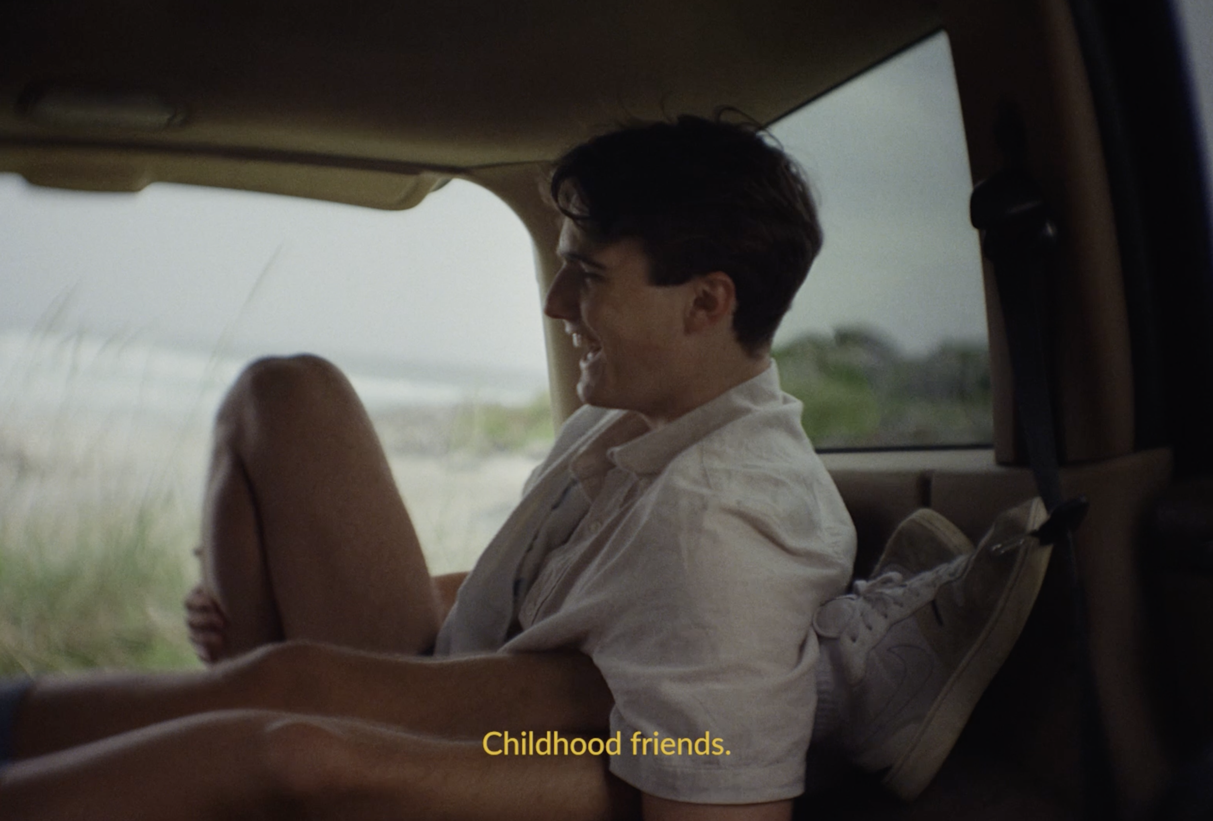 Man sitting in the back of a car in a Bama commercial still, cinematography by Johan-Fredrik Bødtker.