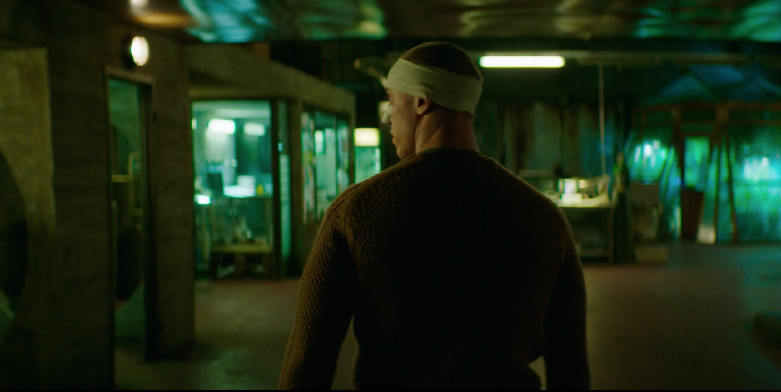 Man walking through an underground industrial space in Valkyrien, cinematography by Johan-Fredrik Bødtker.