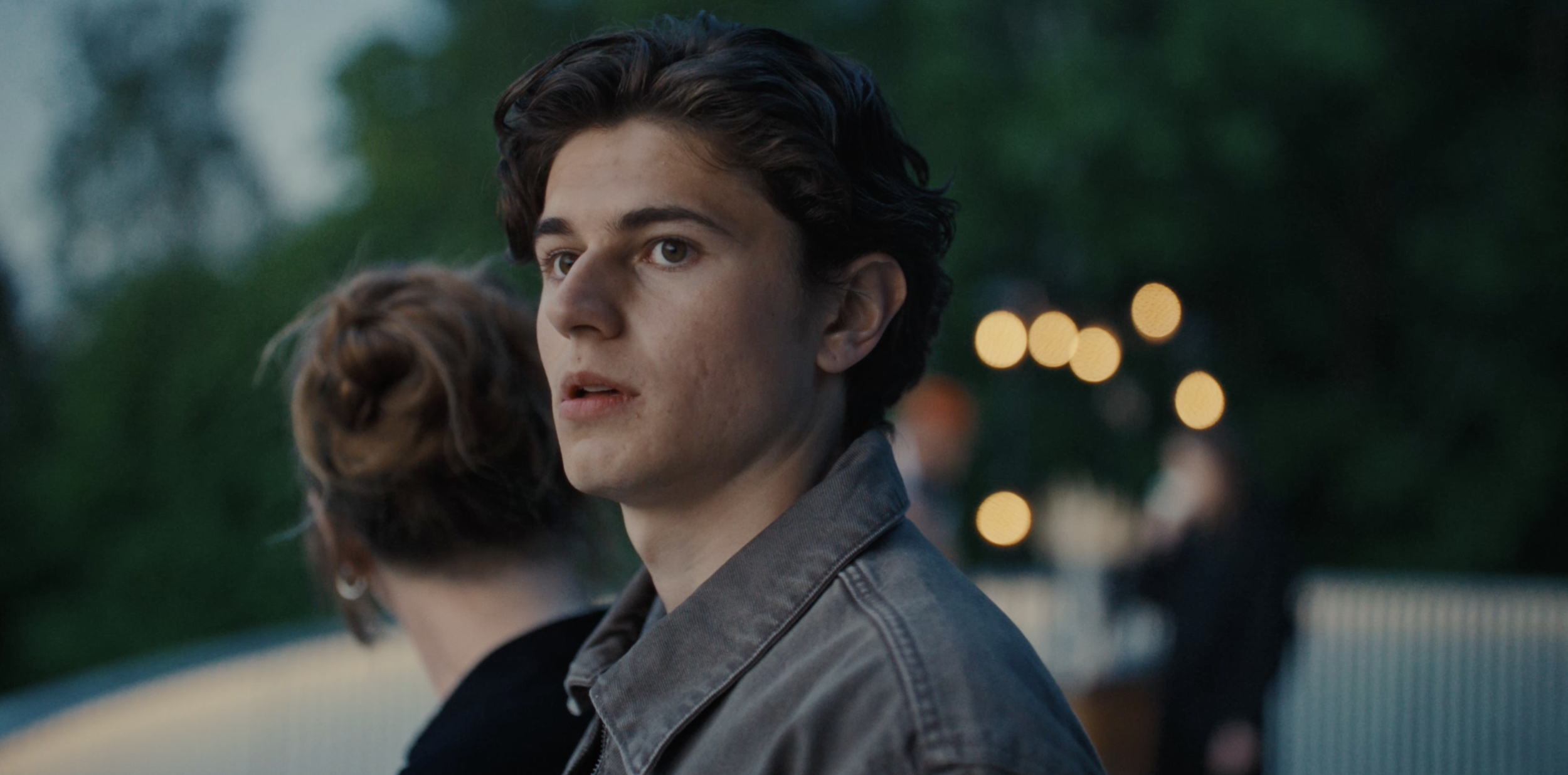 Young man looking to the side outdoors in an Ice commercial, cinematography by Johan-Fredrik Bødtker.