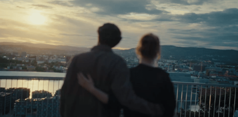 Young couple embracing while looking over a city at sunset in an Ice commercial, cinematography by Johan-Fredrik Bødtker.