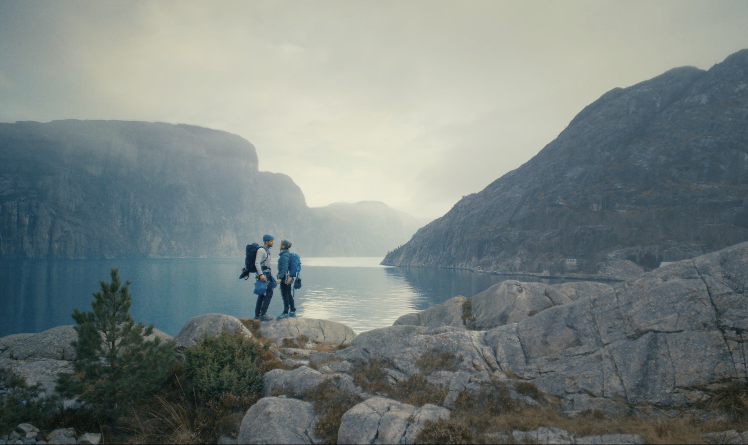Small group standing in a dramatic Norwegian mountain landscape in a Telenor Sikre commercial, cinematography by Johan-Fredrik Bødtker.