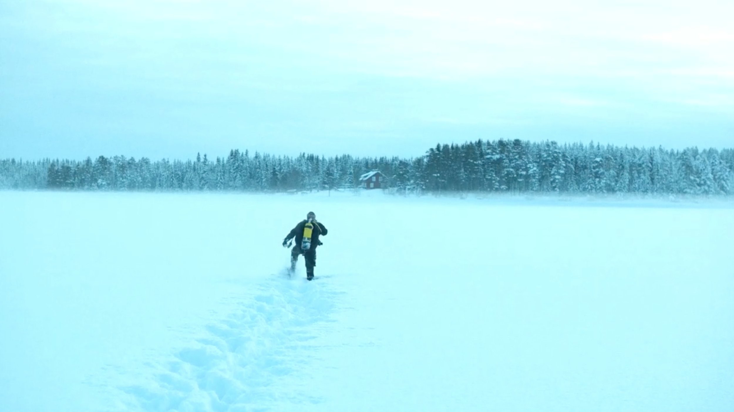 Person in scuba gear crossing a snowy frozen landscape in Lilyhammer, cinematography by Johan-Fredrik Bødtker.