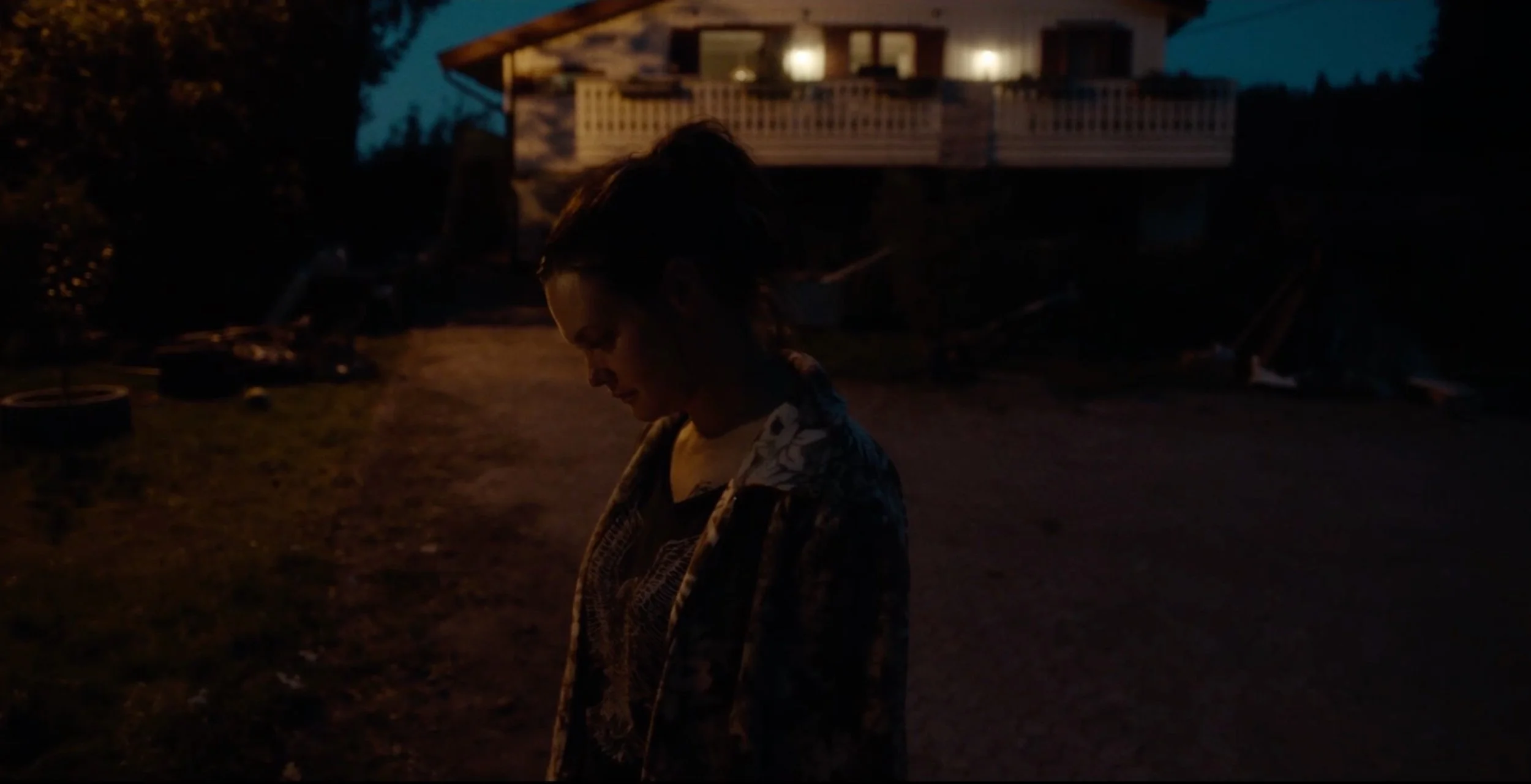 Woman standing outdoors at dusk in Fenris, cinematography by Johan-Fredrik Bødtker.