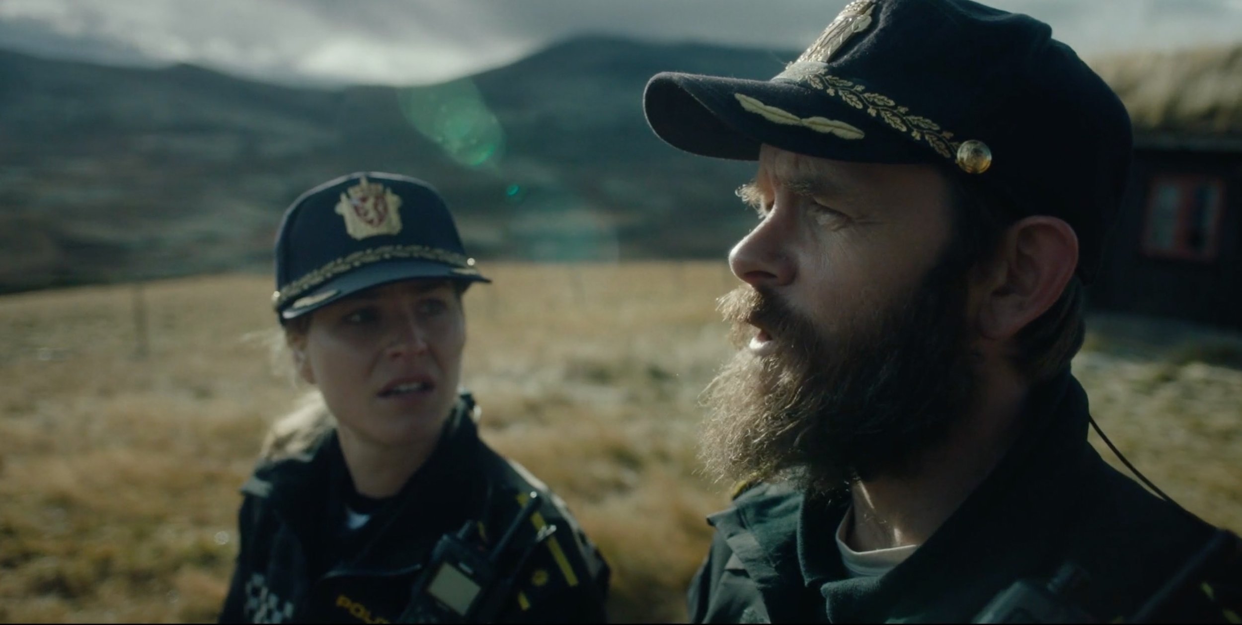 Police officer speaking with a bearded man outdoors in Fenris, cinematography by Johan-Fredrik Bødtker.
