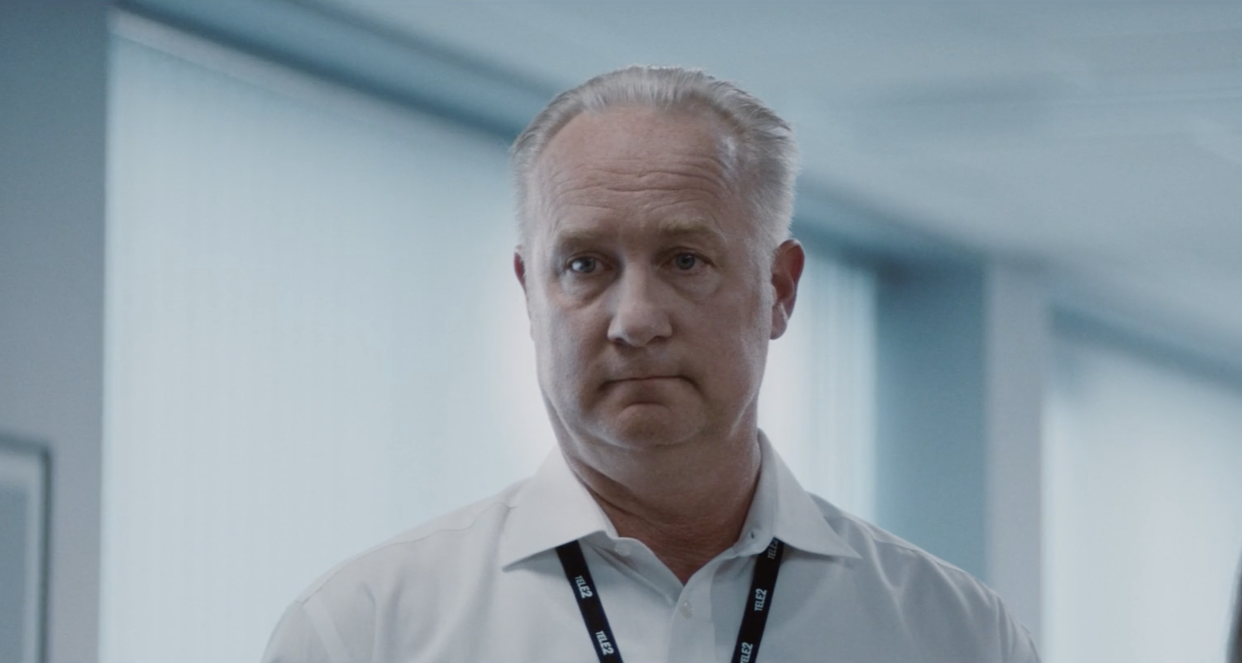 Man in a white shirt standing in an office in a Tele2 commercial, cinematography by Johan-Fredrik Bødtker.