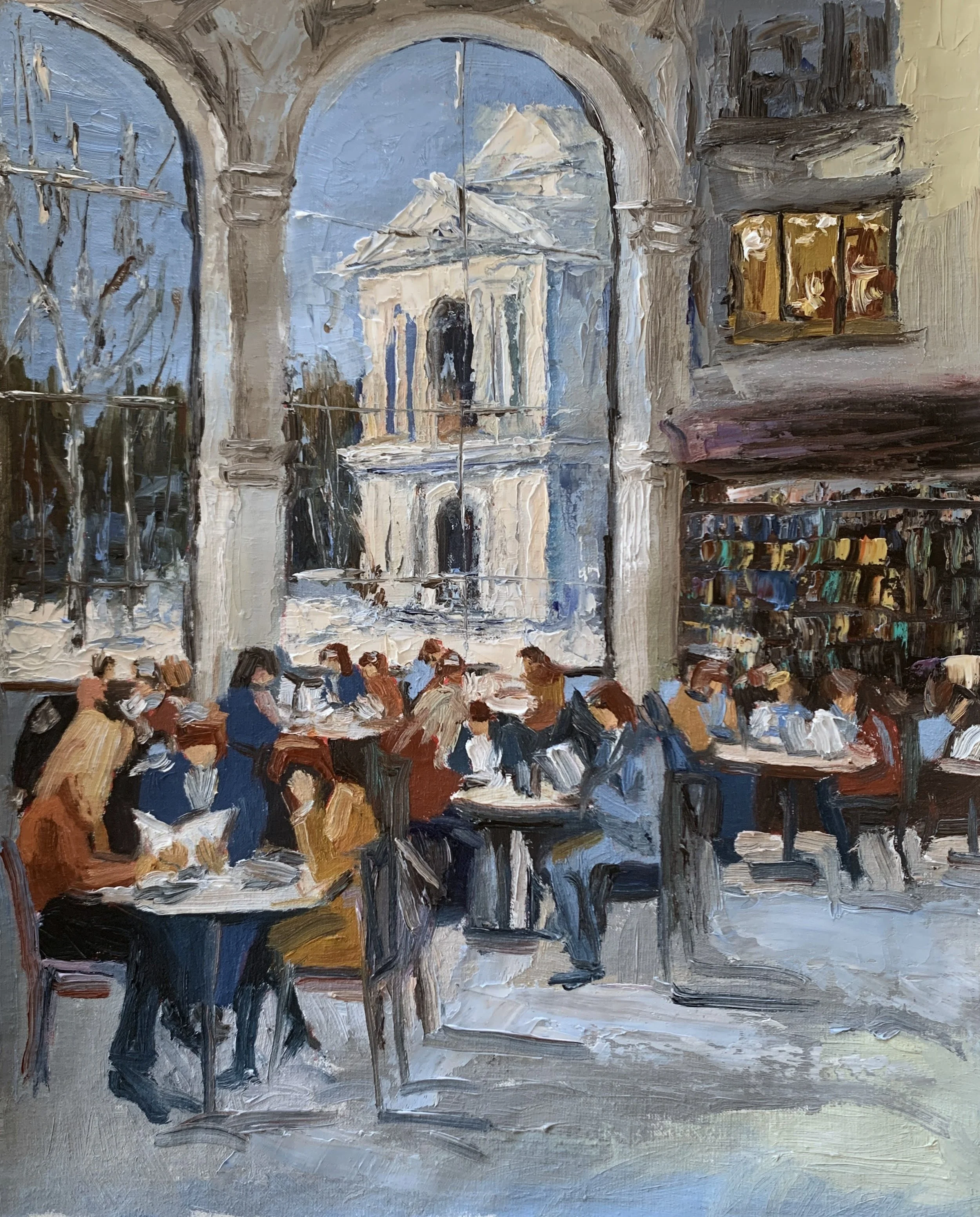 Readers and quiet conversations beneath a monumental arch inside a grand public library