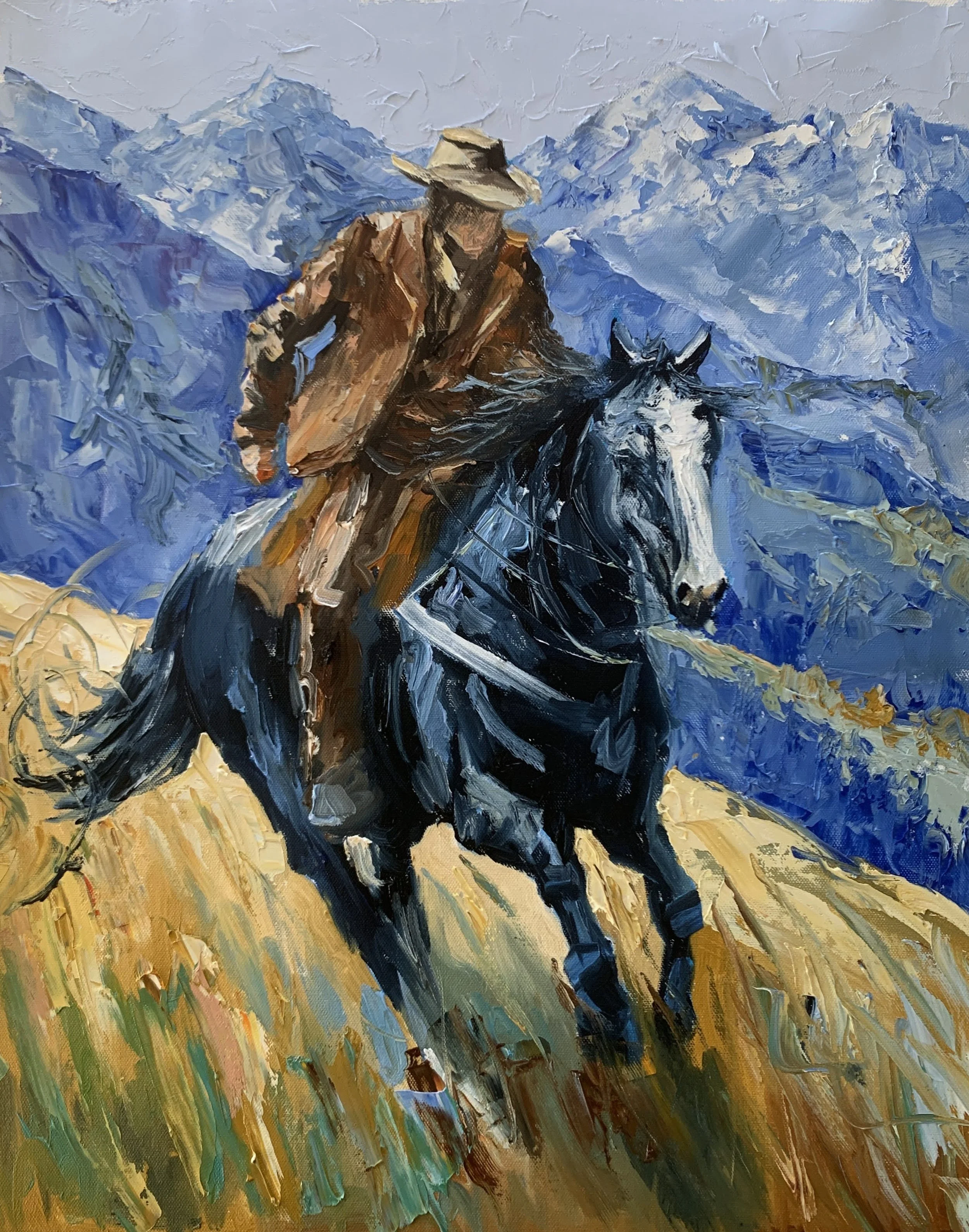 Vita Schagen artwork Cowboy on a dark horse riding across ochre grass beneath layered blue mountain peaks