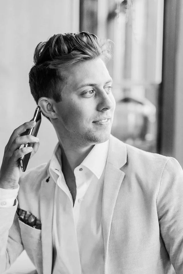The image displays a businessman speaking on the phone. He looks quite relaxed and he is smiling.