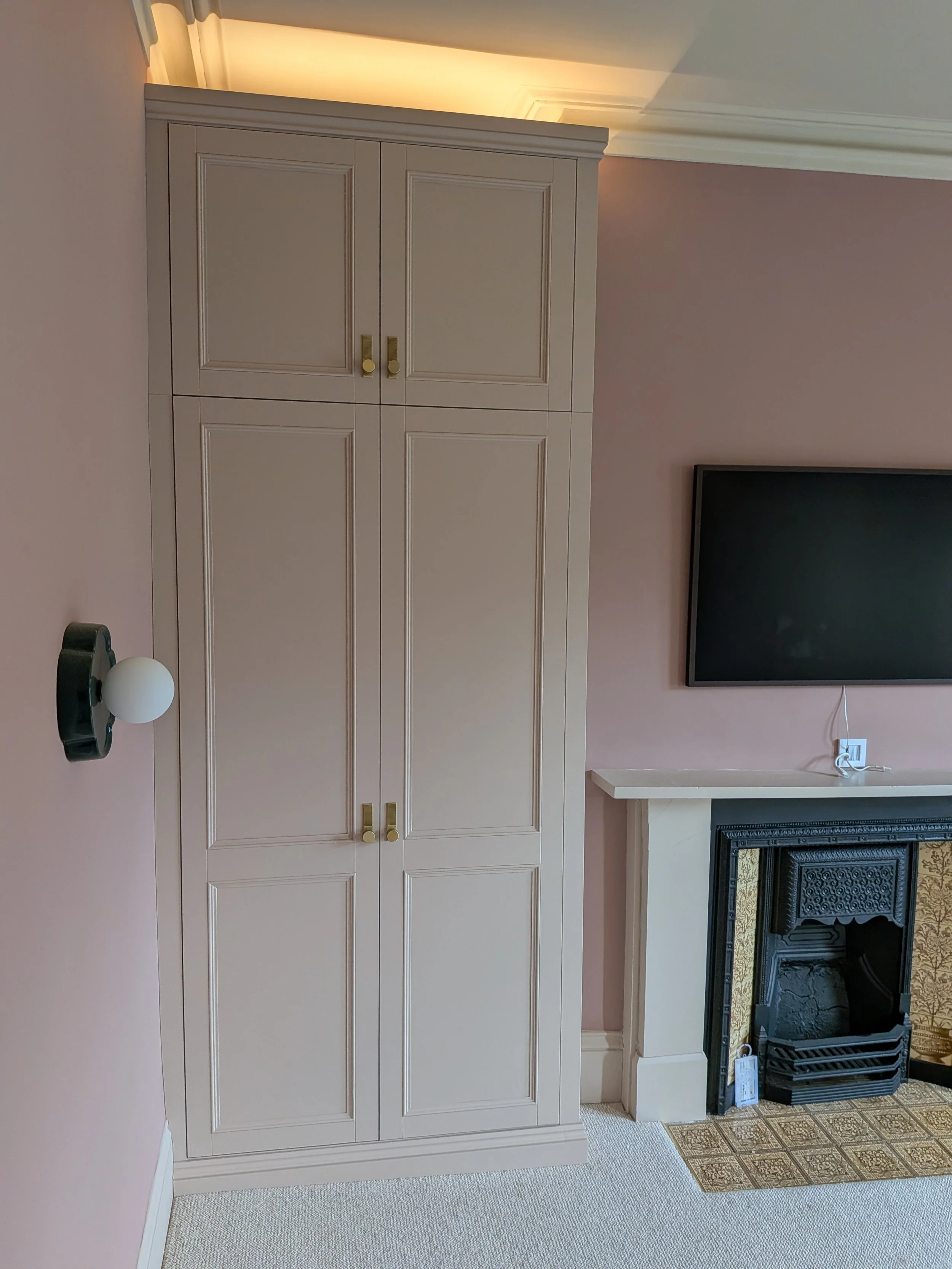 Large, luxury double wardrobes installed in Heaton with integrated lighting, internal shelving and drawers and high quality doorknobs.
