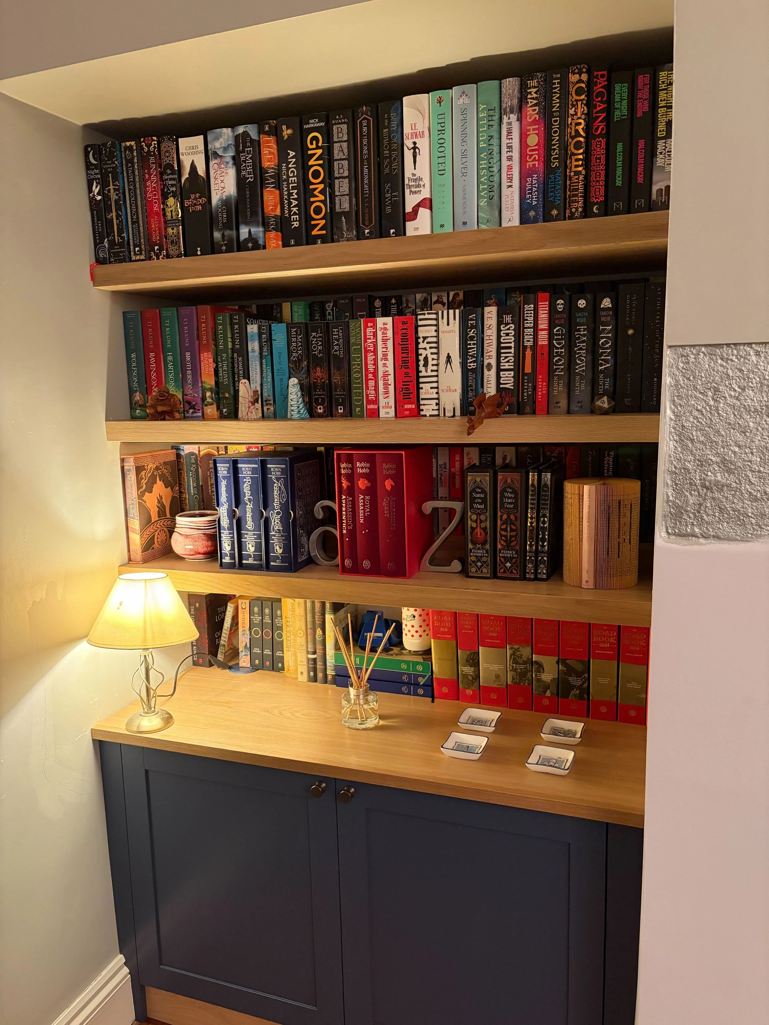 A bespoke installation in Gosforth in a mix of oak and painted finish, including extra deep bookshelves with removable 'lifts' at the back to allow display of a double layer of paperback books in a small space.