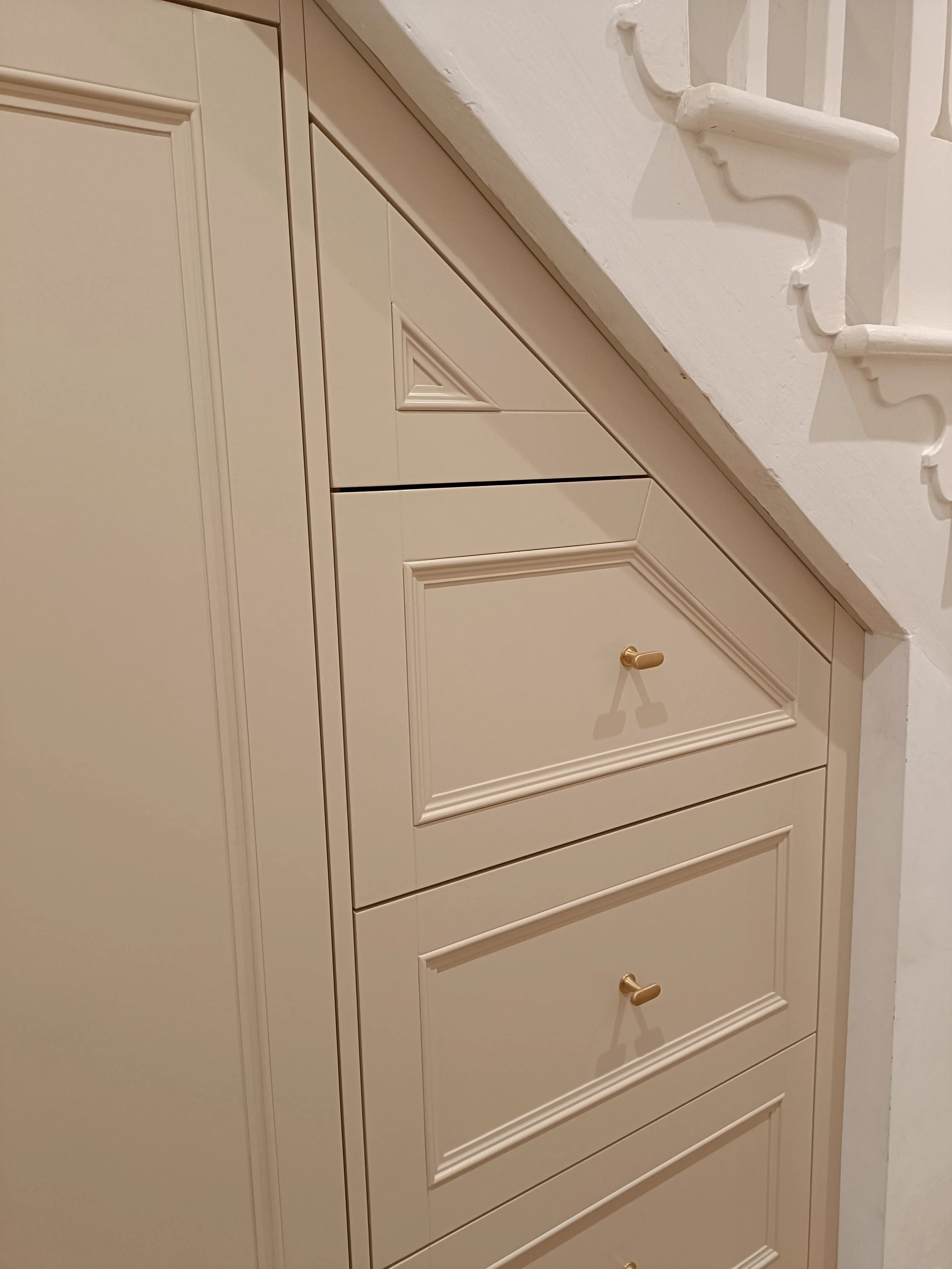 Bespoke understairs storage installed in Gosforth, with XXL pull out drawers and a large double door cupboard.