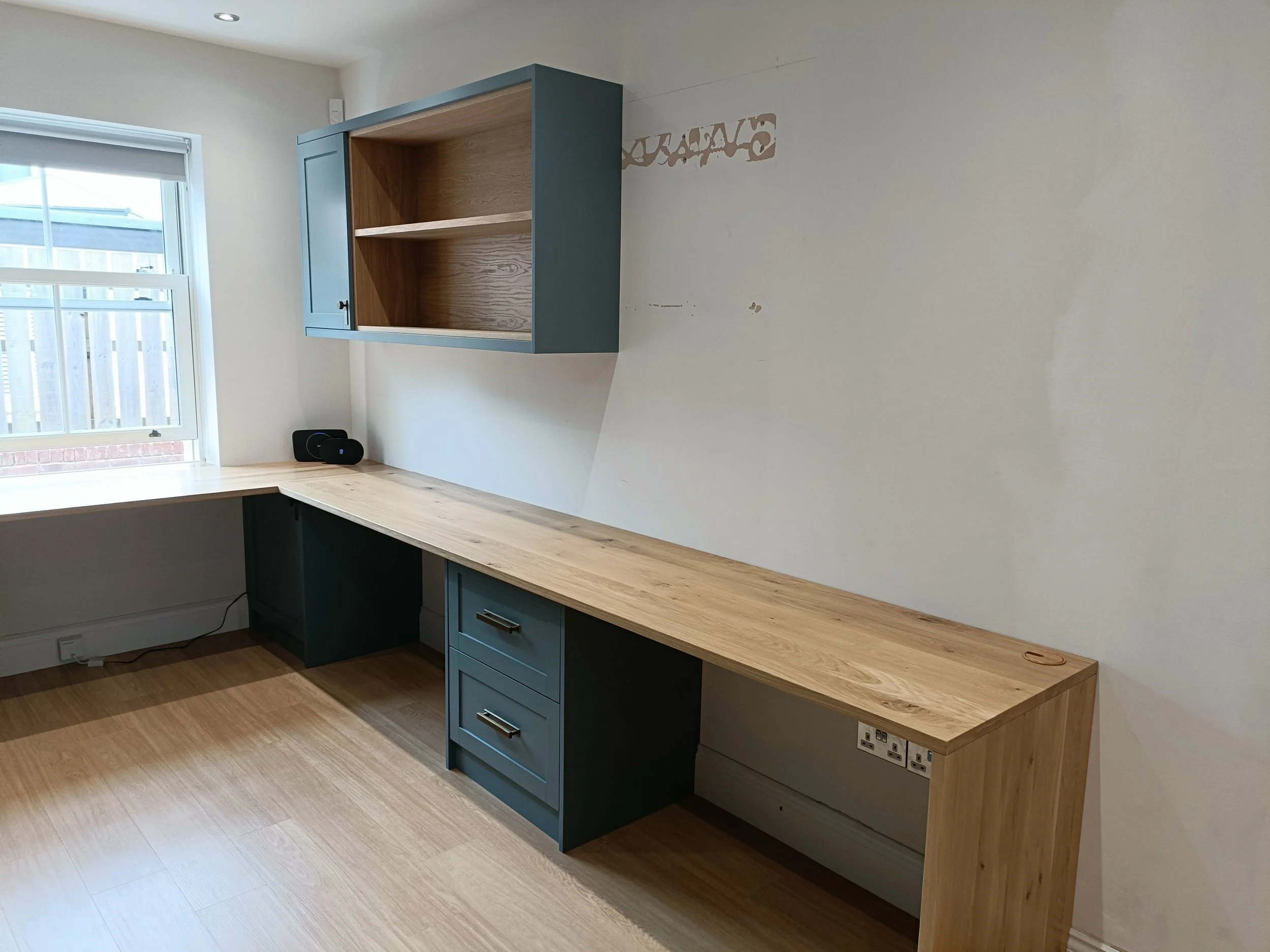 Office with desk space, open shelving and closed storage made bespoke, spray painted and installed in Ponteland.