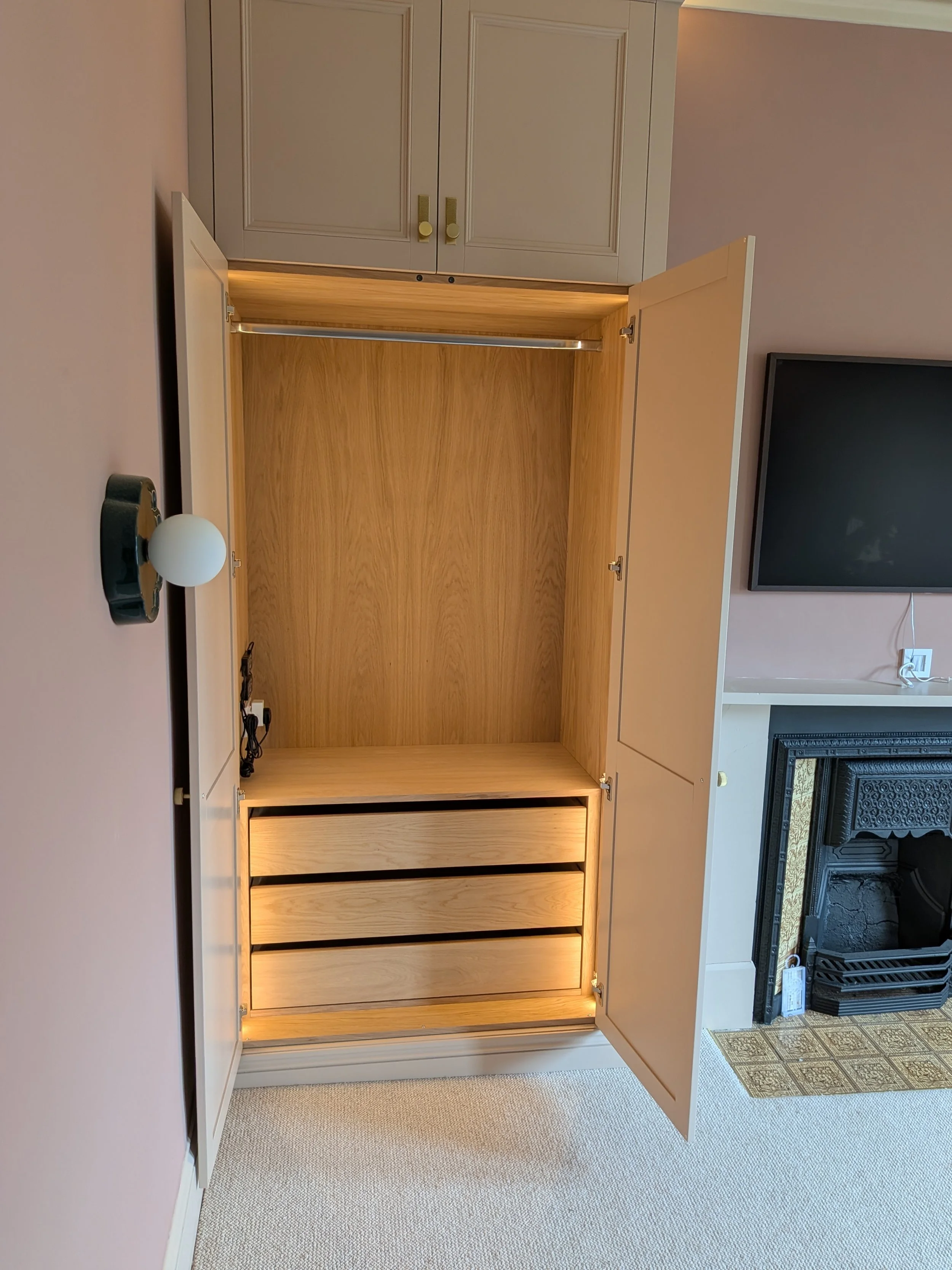 Large, luxury double wardrobes installed in Heaton with integrated lighting, internal shelving and drawers and high quality doorknobs.