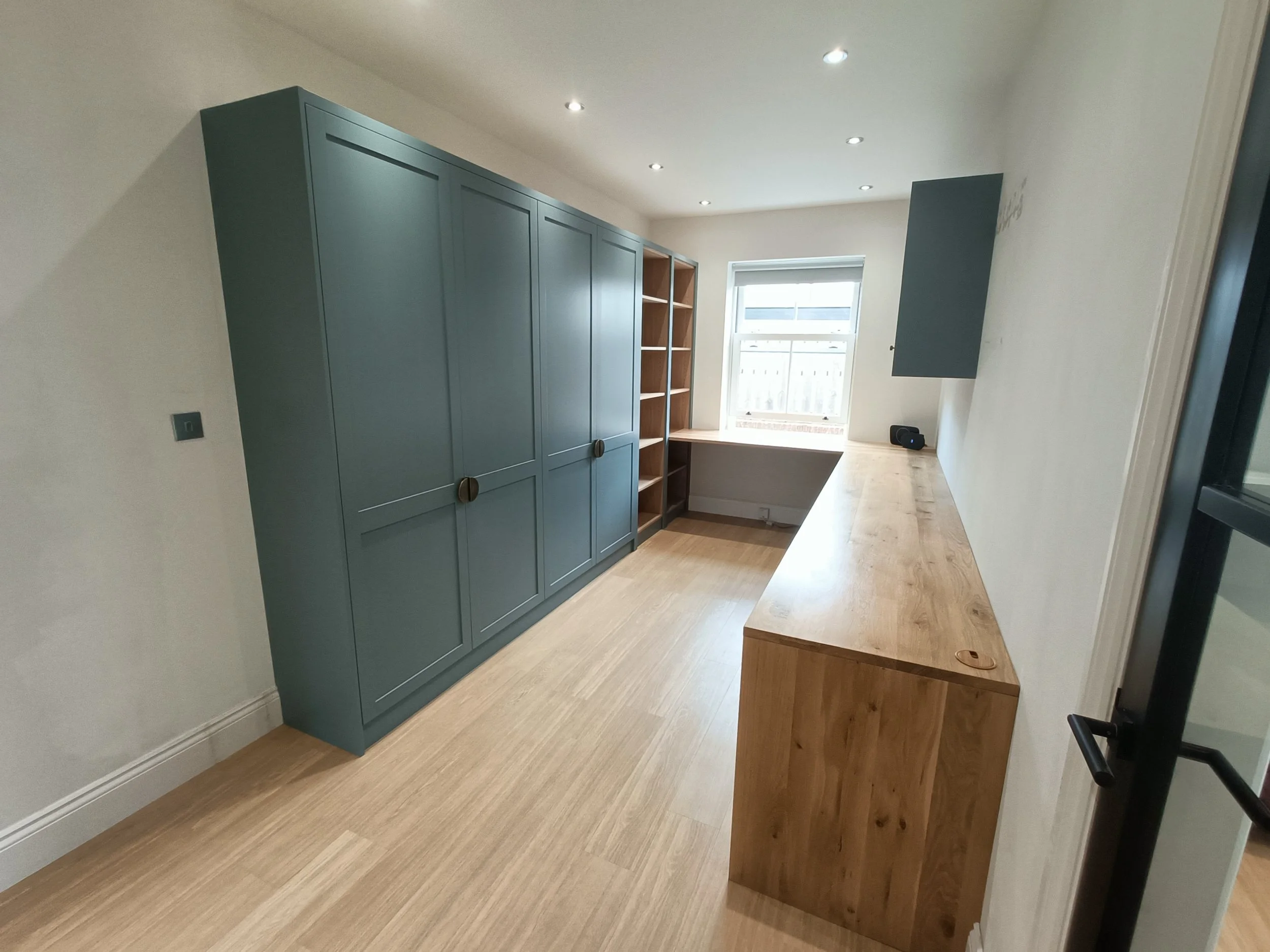 Office with desk space, open shelving and closed storage made bespoke, spray painted and installed in Ponteland.
