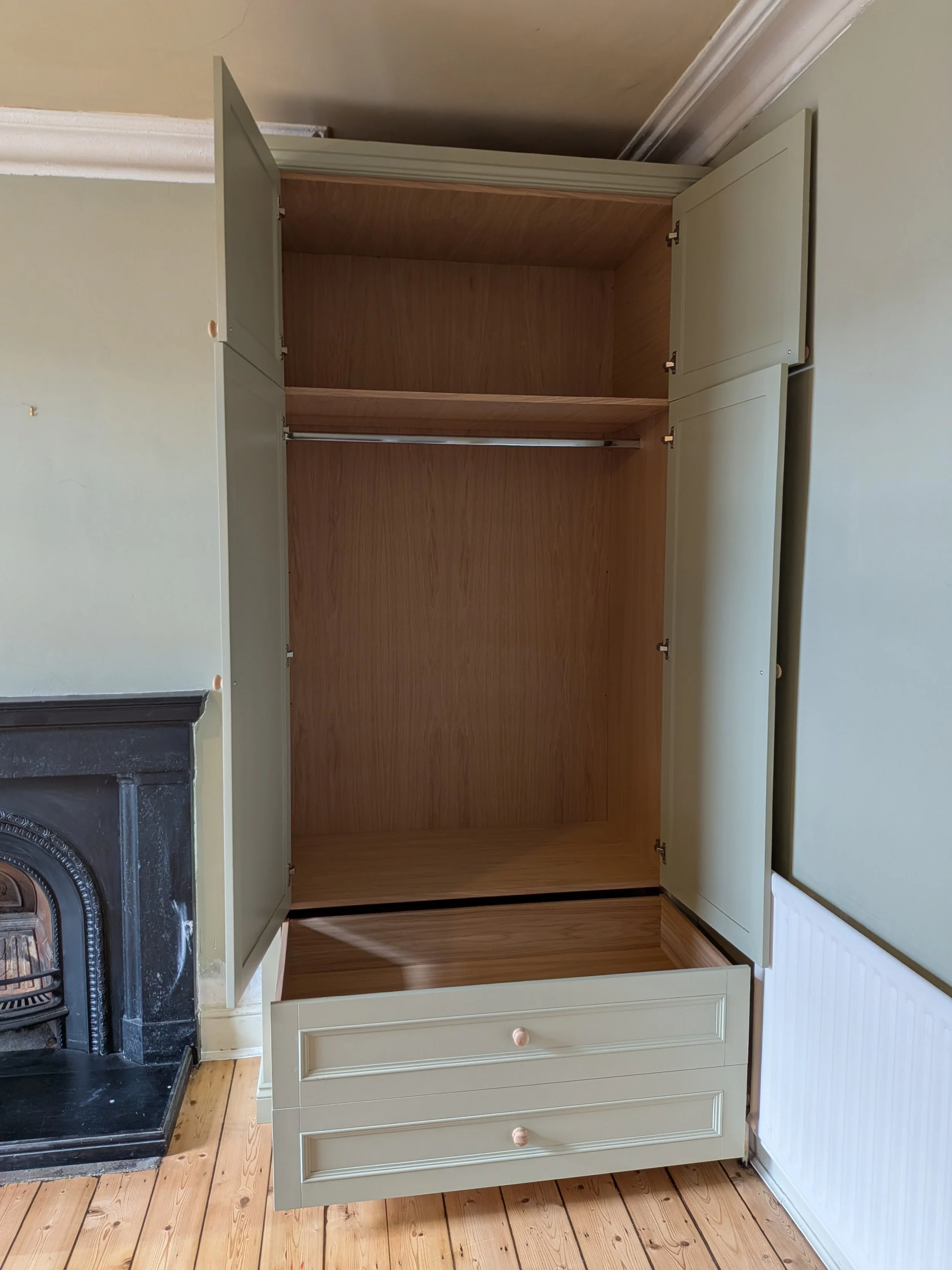 Pair of traditional style wardrobes with large drawers installed in Gosforth. Photo shows oak interior.