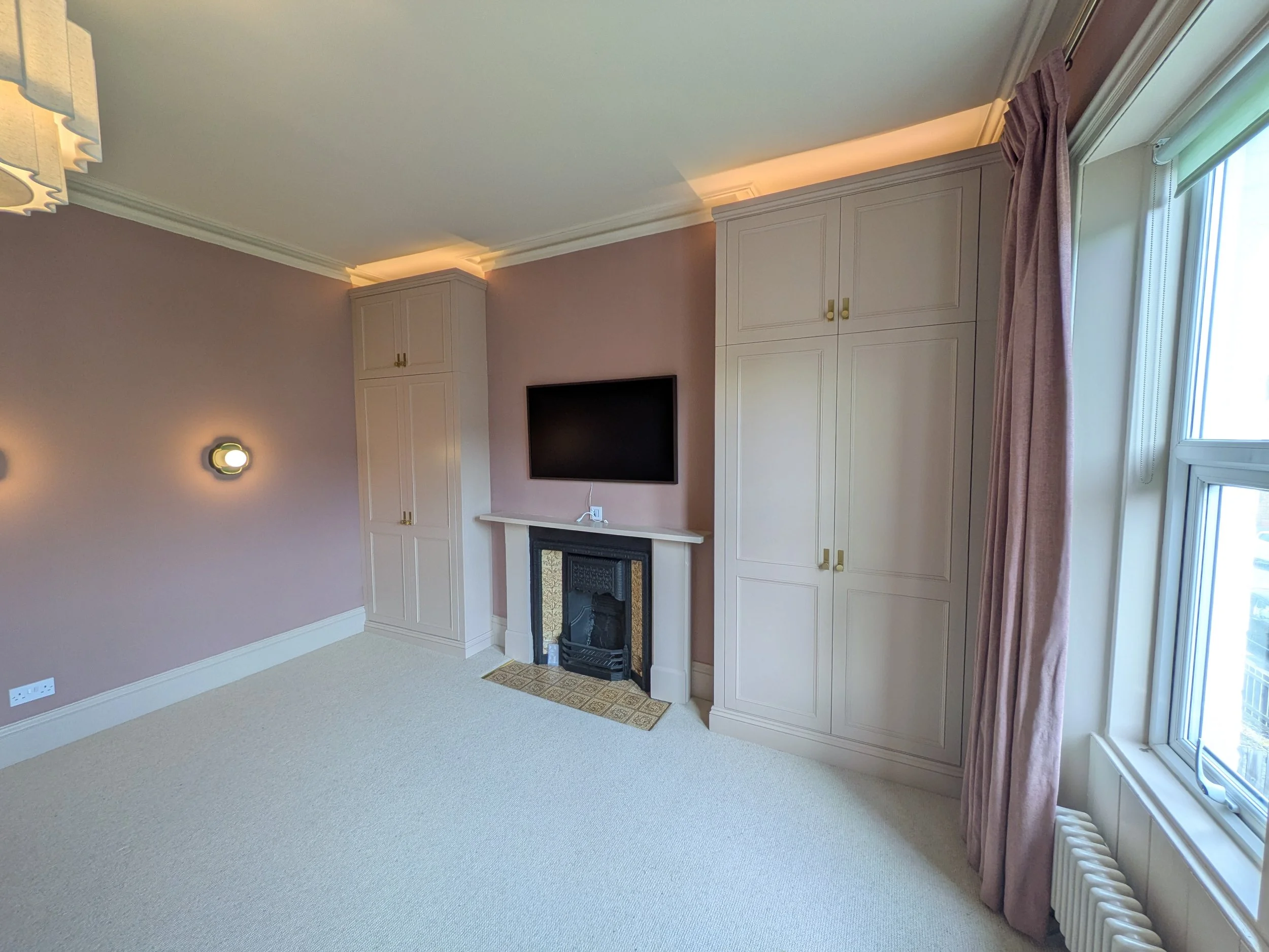 Large, luxury double wardrobes installed in Heaton with integrated lighting, internal shelving and drawers and high quality doorknobs.