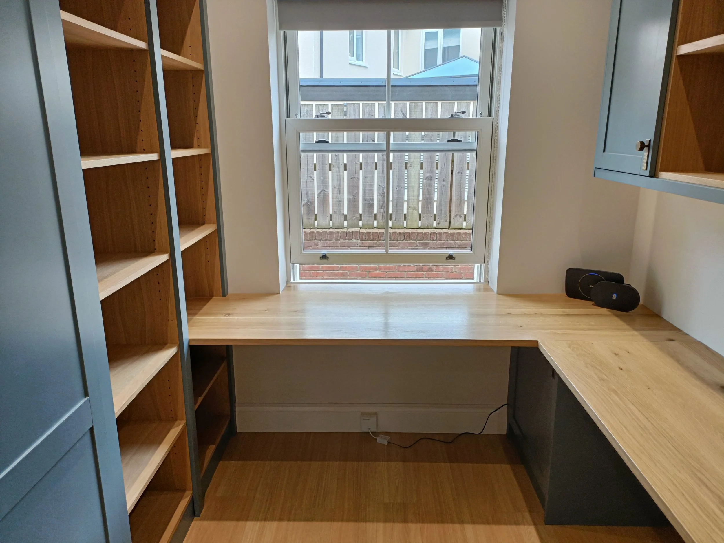 Office with desk space, open shelving and closed storage made bespoke, spray painted and installed in Ponteland.