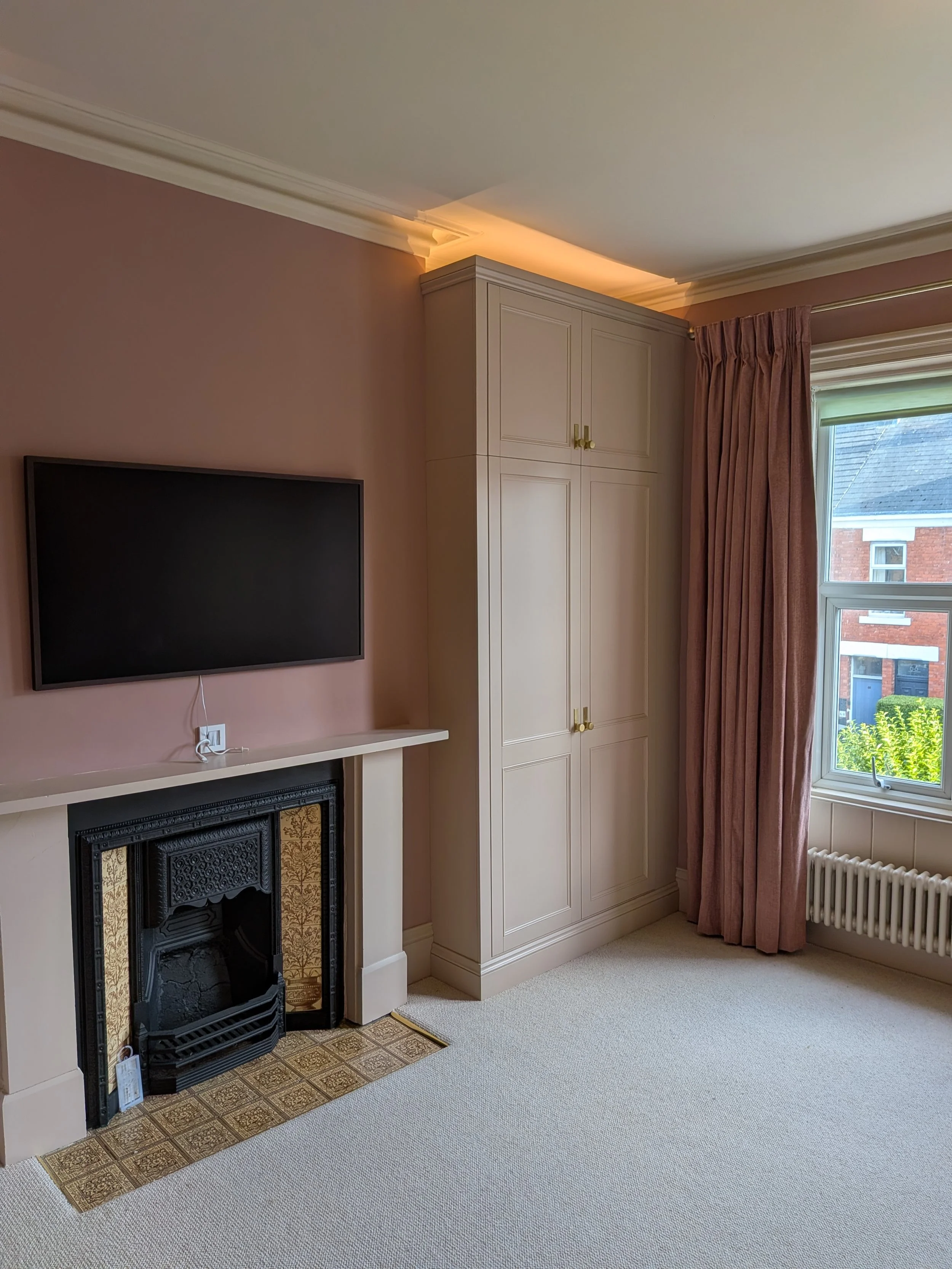 Large, luxury double wardrobes installed in Heaton with integrated lighting, internal shelving and drawers and high quality doorknobs.