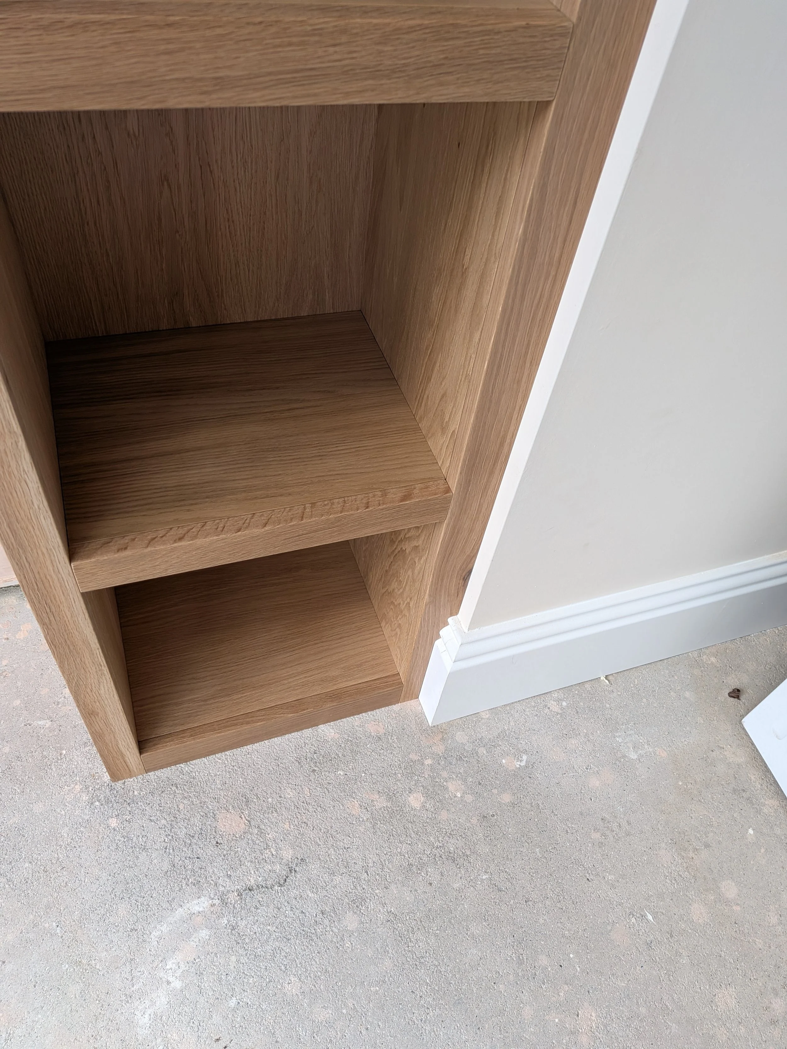 Oak window seat and surround with integrated bookcase installed in a new kitchen extension in Tynemouth. 